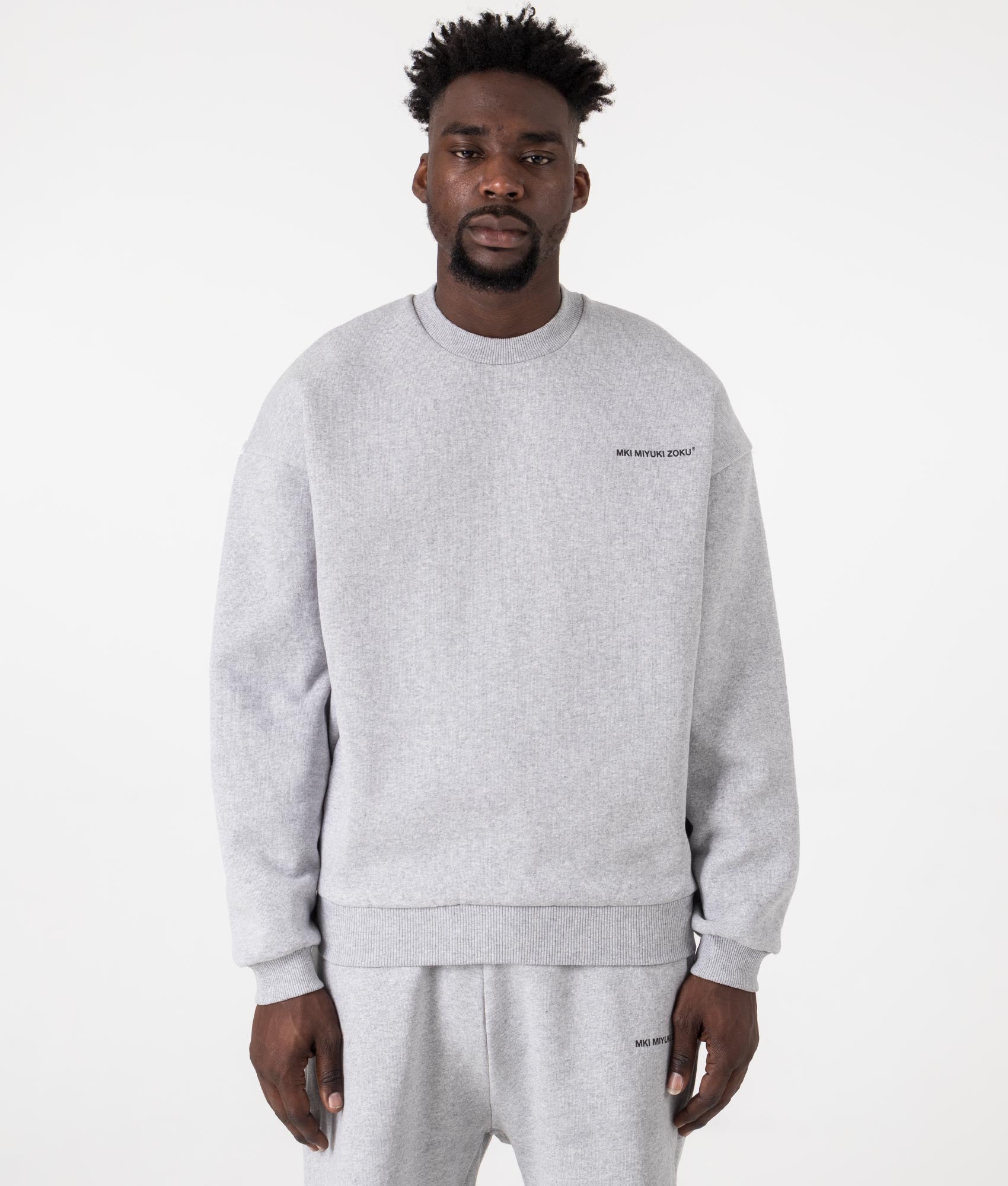 MKI MIYUKI ZOKU Oversized Uniform Crewneck Sweatshirt in grey at EQVVS Menswear. Model front shot.