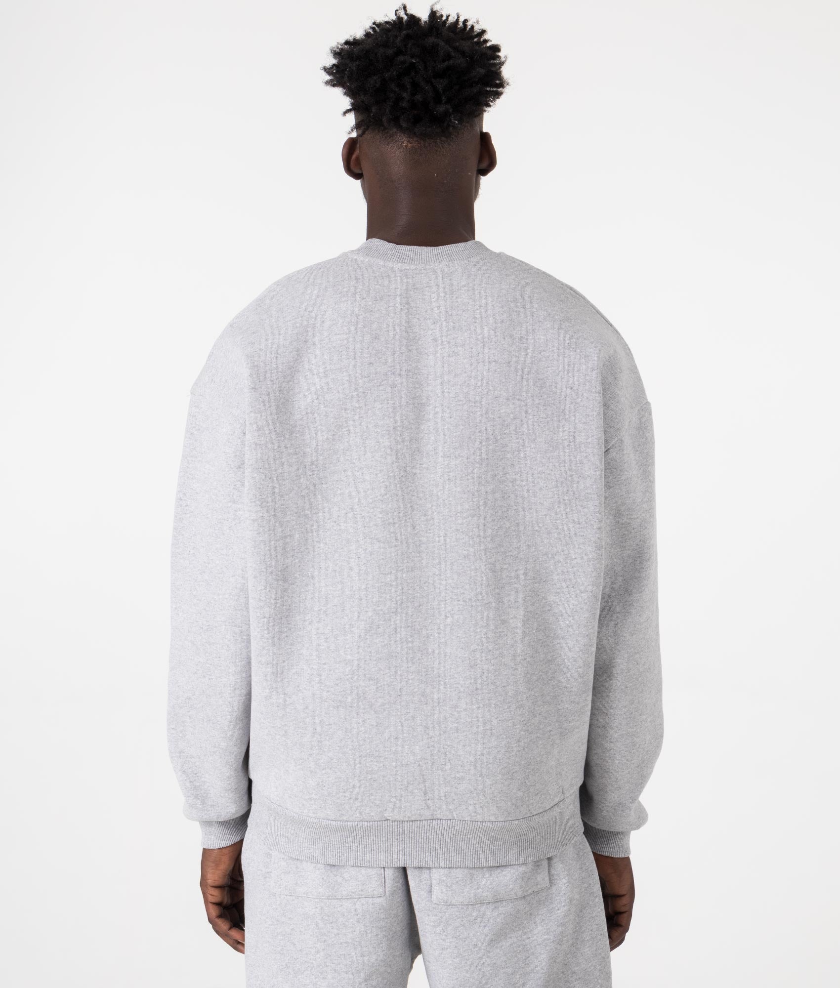 MKI MIYUKI ZOKU Oversized Uniform Crewneck Sweatshirt in grey at EQVVS Menswear. Model back shot.