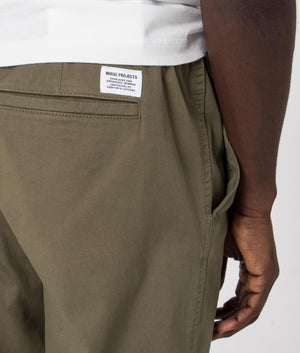 Ezra Relaxed Organic Stretch Twill Pants in Sediment Green by Norse Projects. EQVVS detail shot.