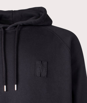Norse Projects Relaxed Fit Marten Raglan N Patch Hoodie in Black at EQVVS Menswear Detail Shot