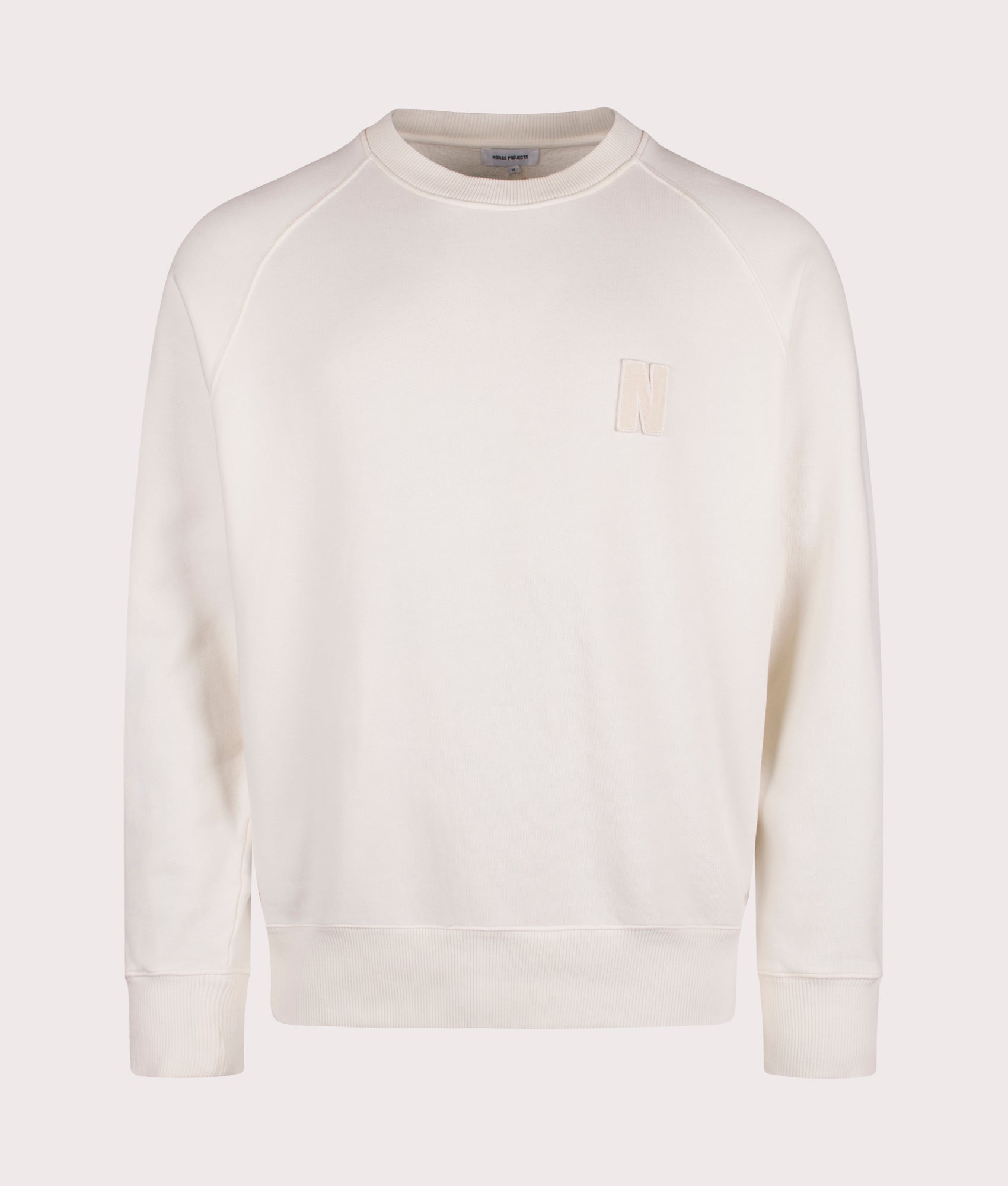Norse Projects Relaxed Fit Marten Raglan N Patch Sweatshirt in Ecru at EQVVS Menswear Front Shot
