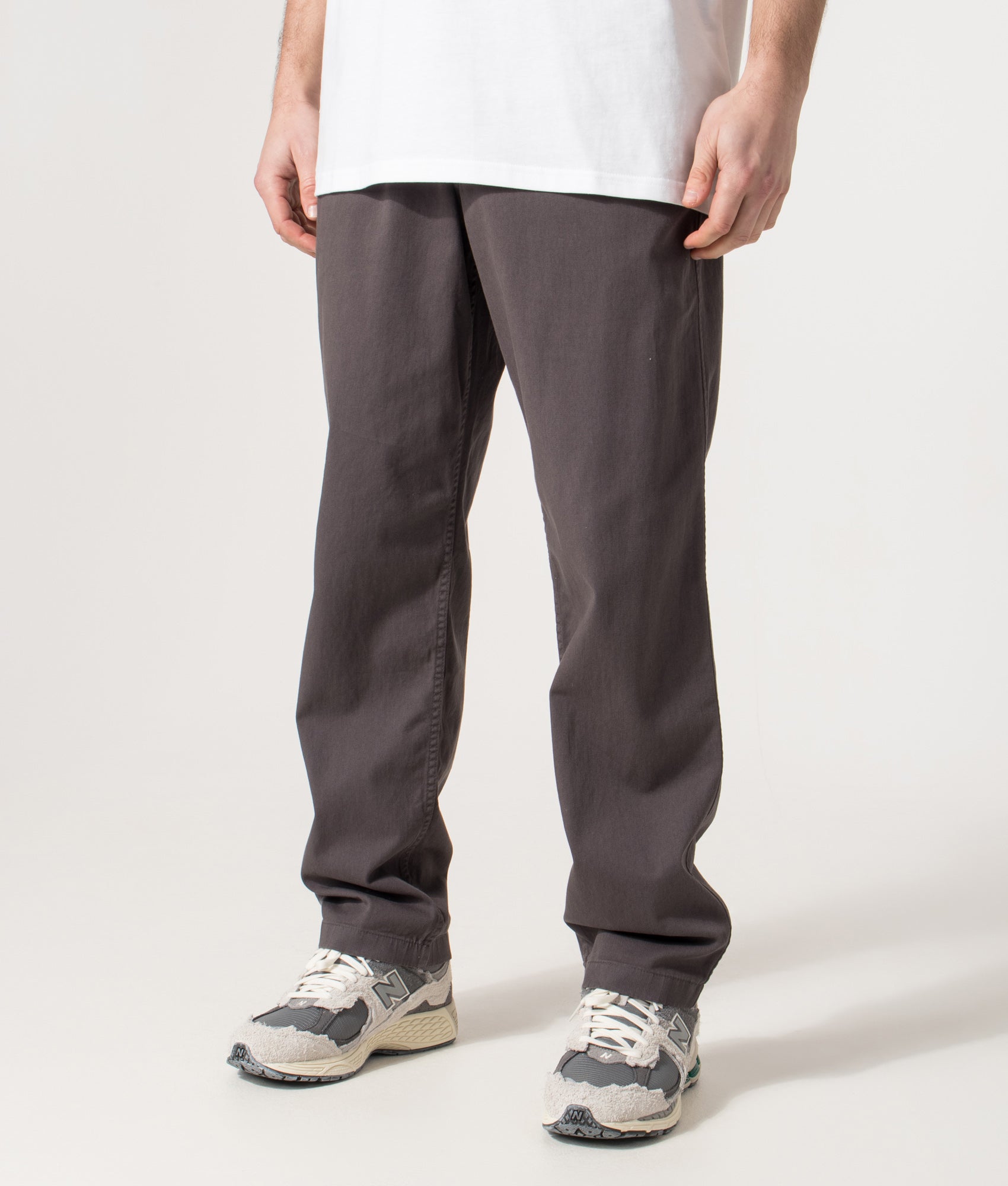 Norse Projects Relaxed Fit Ezra Organic Stretch Twill Trousers in Graphite at EQVVS Menswear. Angled model front shot.