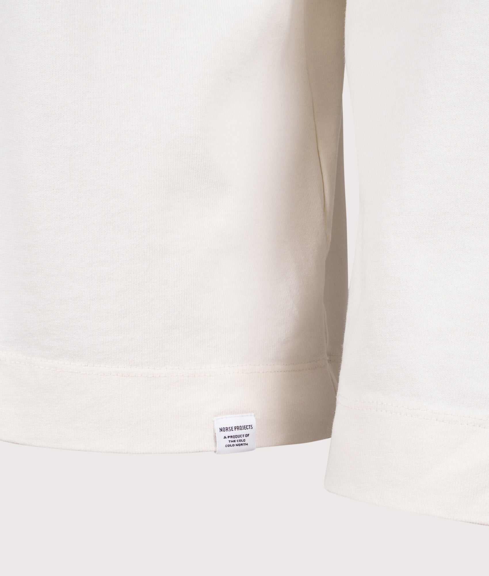 Norse Projects Relaxed Fit Isefjord Compact Long Sleeve T-Shirt in Ecru at EQVVS Menswear. Detail shot.