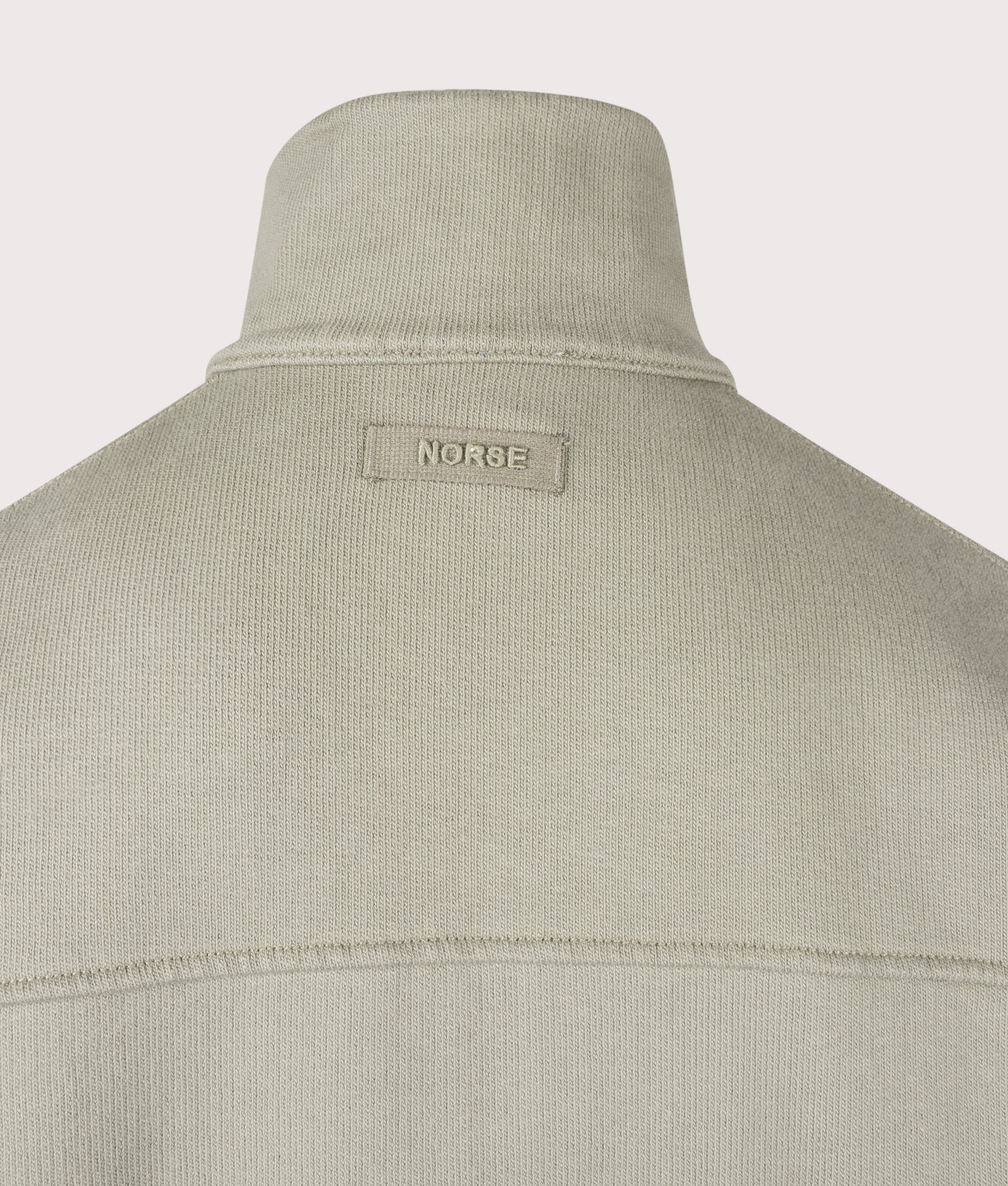 Norse Projects Hornidal Relaxed Organic Loopback Track Jacket in  Vetiver at EQVVS Menswear. Detail shot.