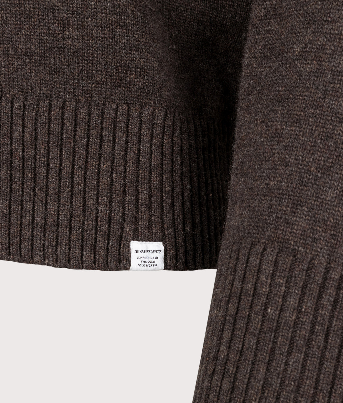 Norse Projects Relaxed Fit Ristinge Long Sleeve Merino Knitted Polo Shirt in the Heathland Brown at EQVVS Menswear. Detail shot.