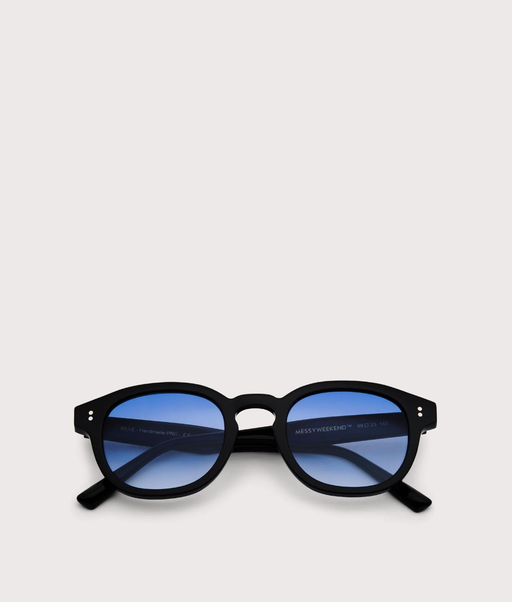MessyWeekend Billie Bio Sunglasses in black and gradient blue Lens at EQVVS. Folded Shot.