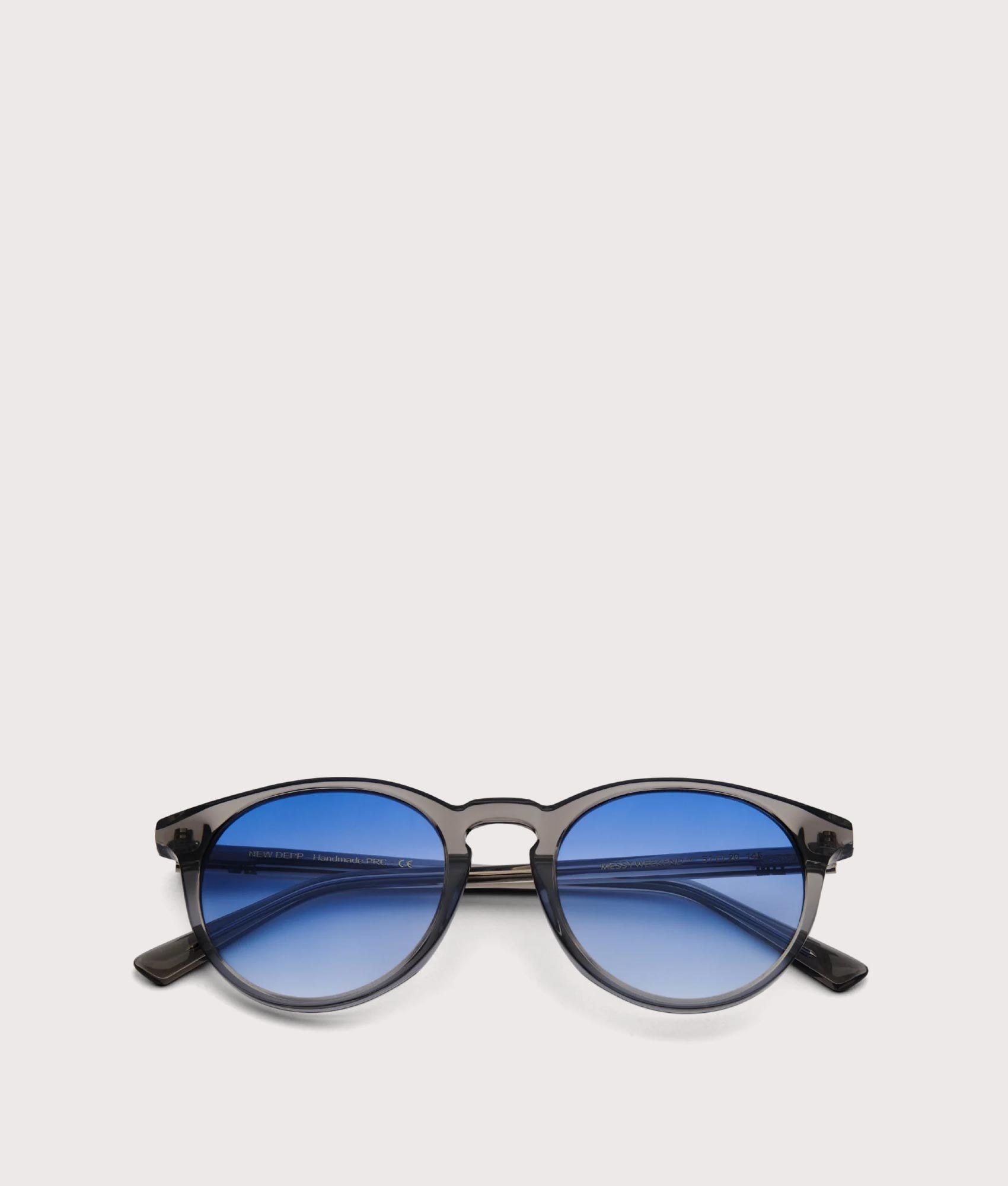 MESSYWEEKEND New Depp Sunglasses in Transparent Grey with Gradient Blue Lens at EQVVS. Folded Shot.