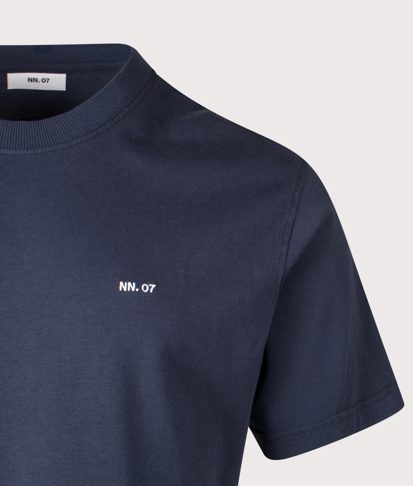 NN.07 Adam EMB T-Shirt in Navy Blue at EQVVS Menswear. Detail shot.