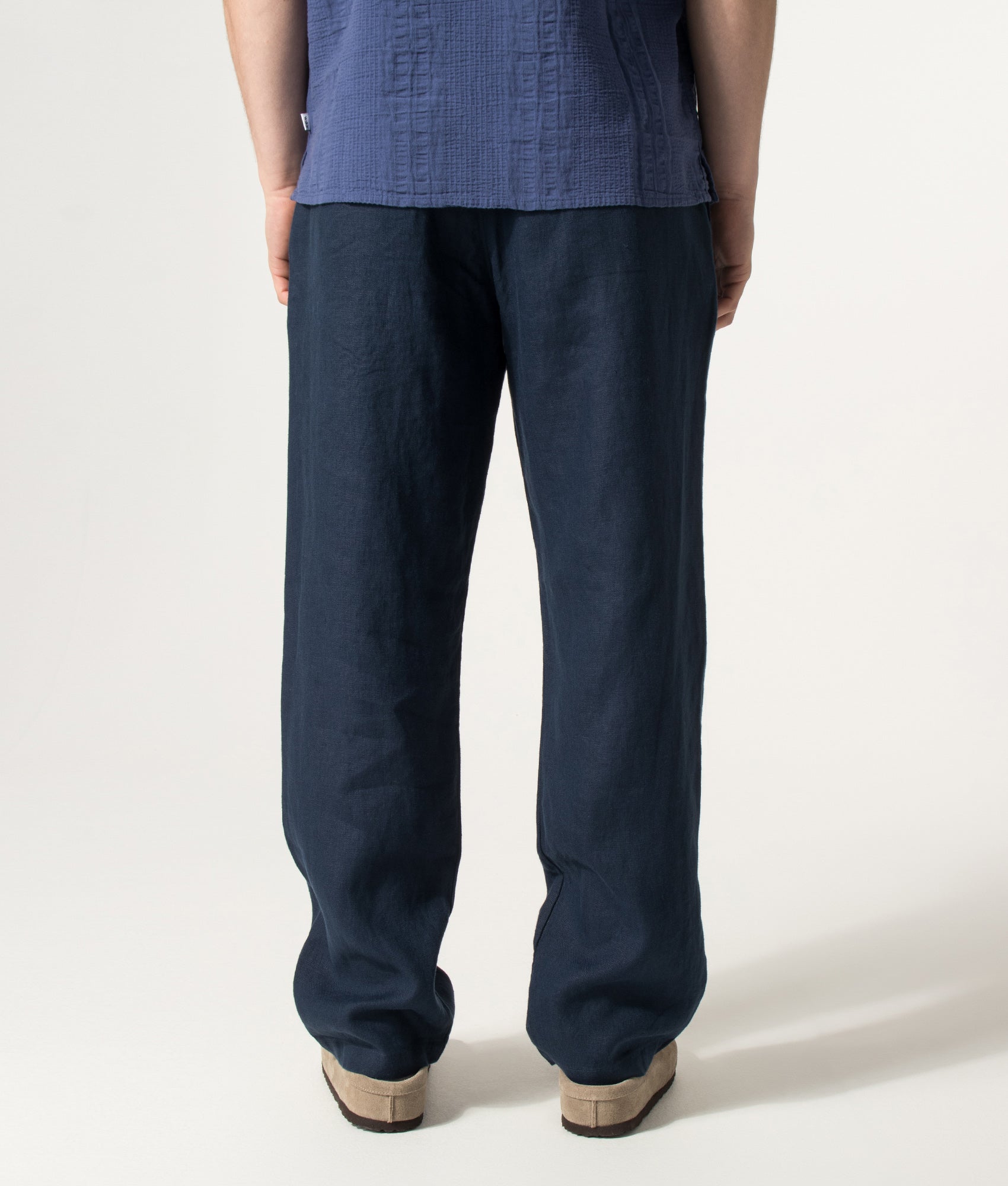 NN.07 Regular Fit Straight Leg Aden Chinos in Navy Blue at EQVVS Menswear. Model back shot.