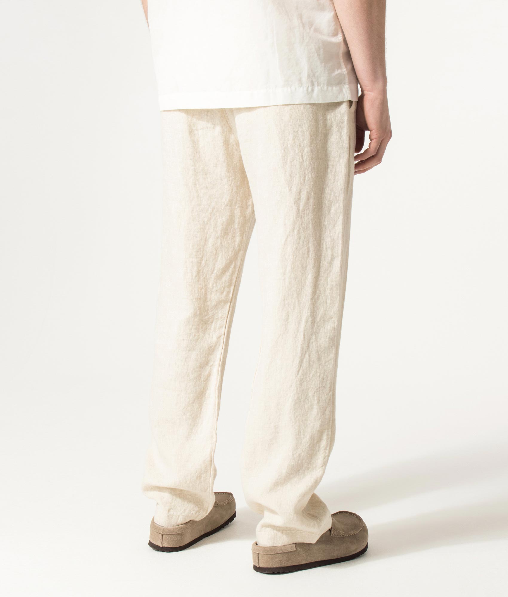 NN.07 Regular Fit Straight Leg Aden Chinos in Oat at EQVVS Menswear. Angled model back shot.