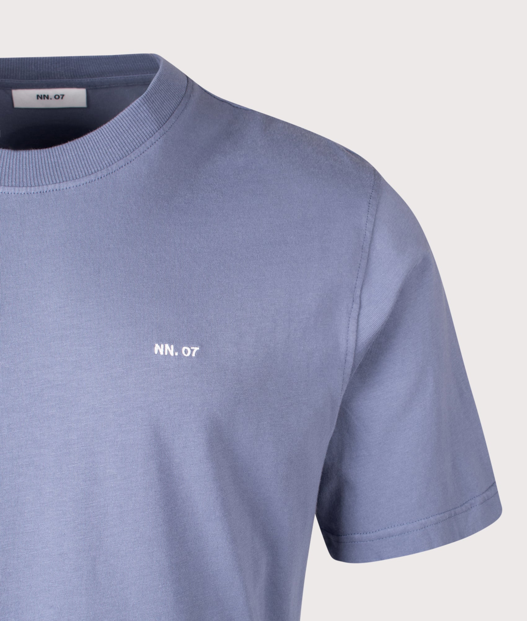 NN.07 Adam EMB T-Shirt in Stone Blue at EQVVS Menswear. Detail shot.