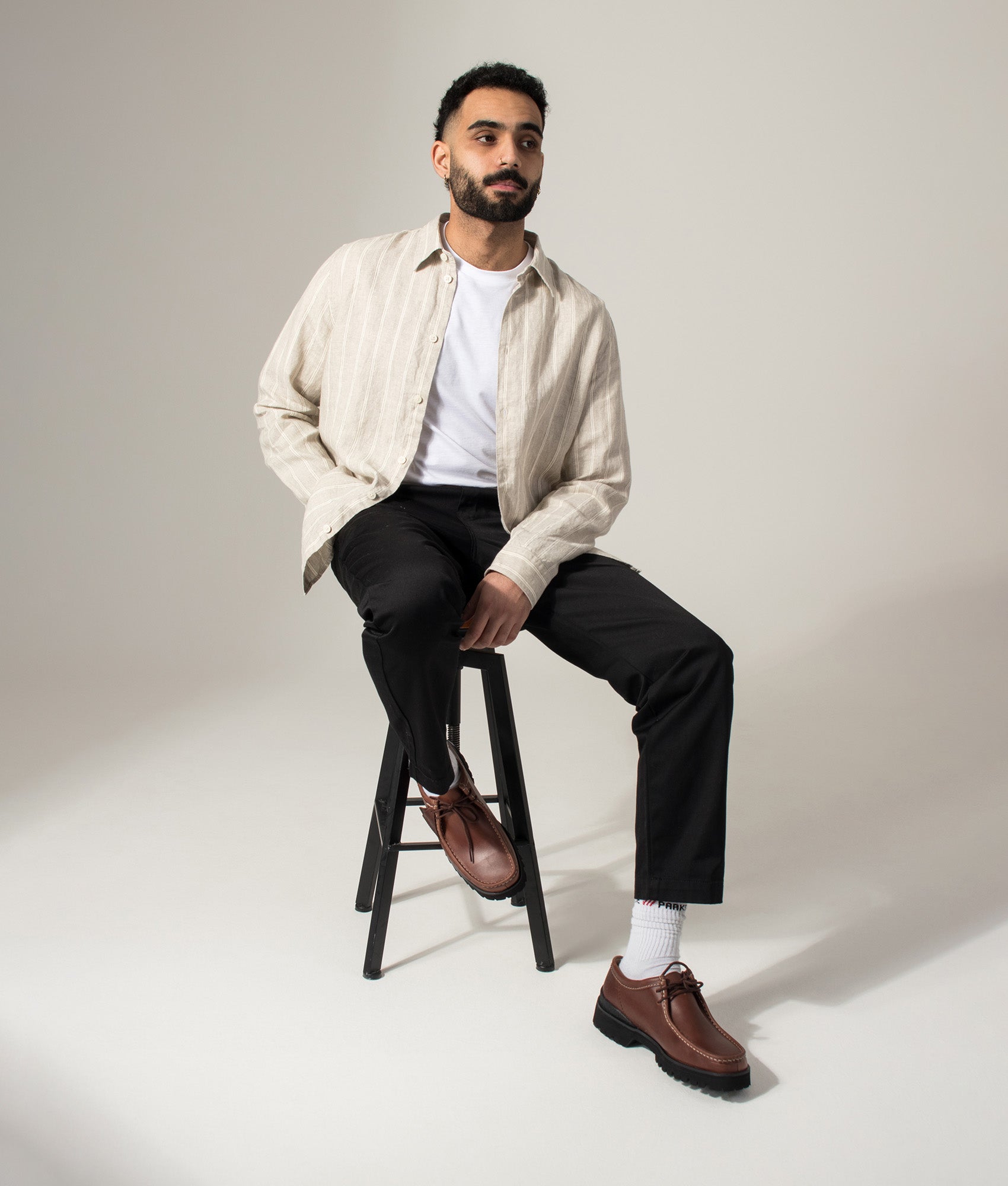 NN.07 Enzo Linen Shirt in Oat Stripe at EQVVS Menswear. Model shot.