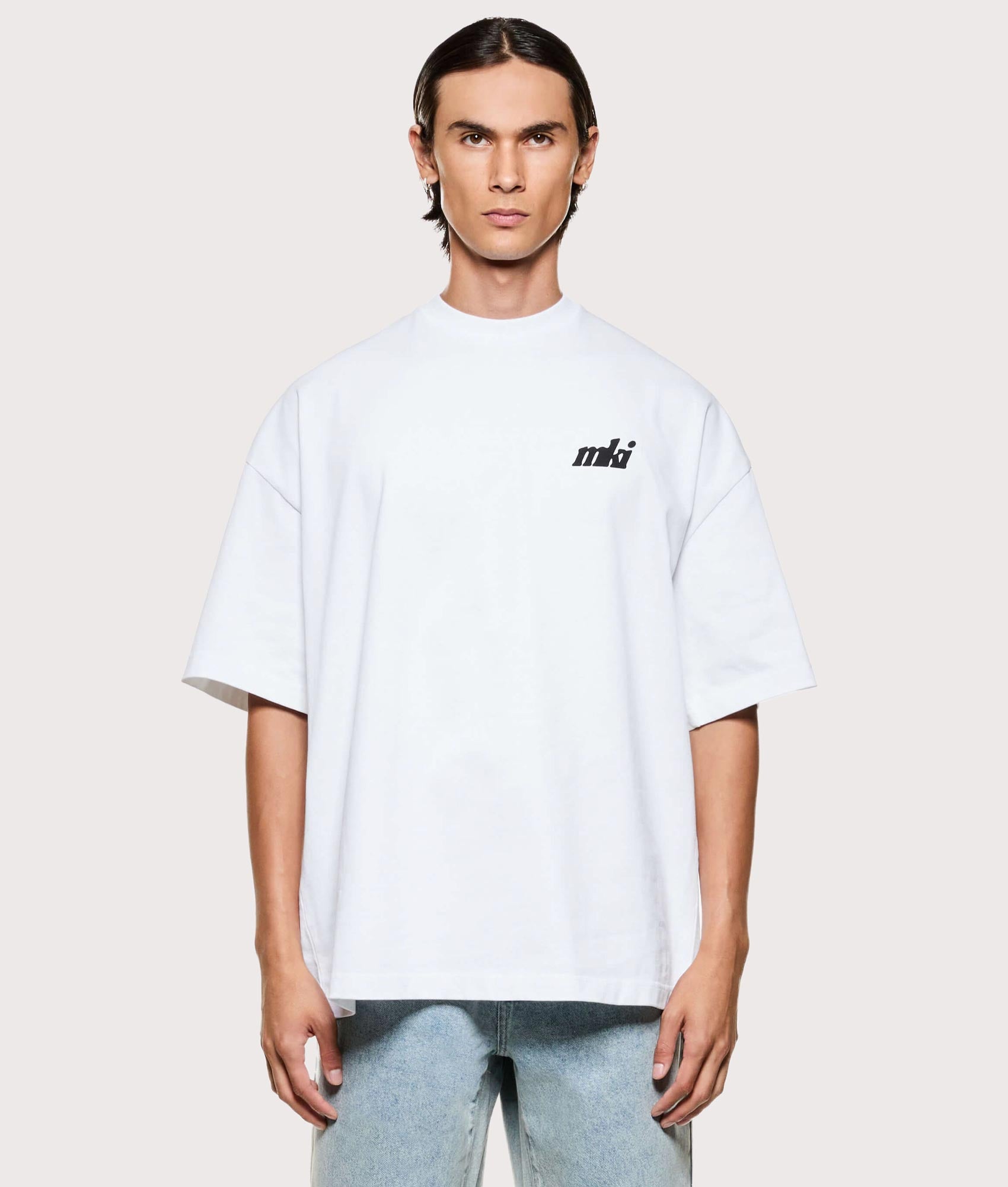 MKI MIYUKI ZOKU Stamp T-Shirt in white at EQVVS Menswear. Model front shot.