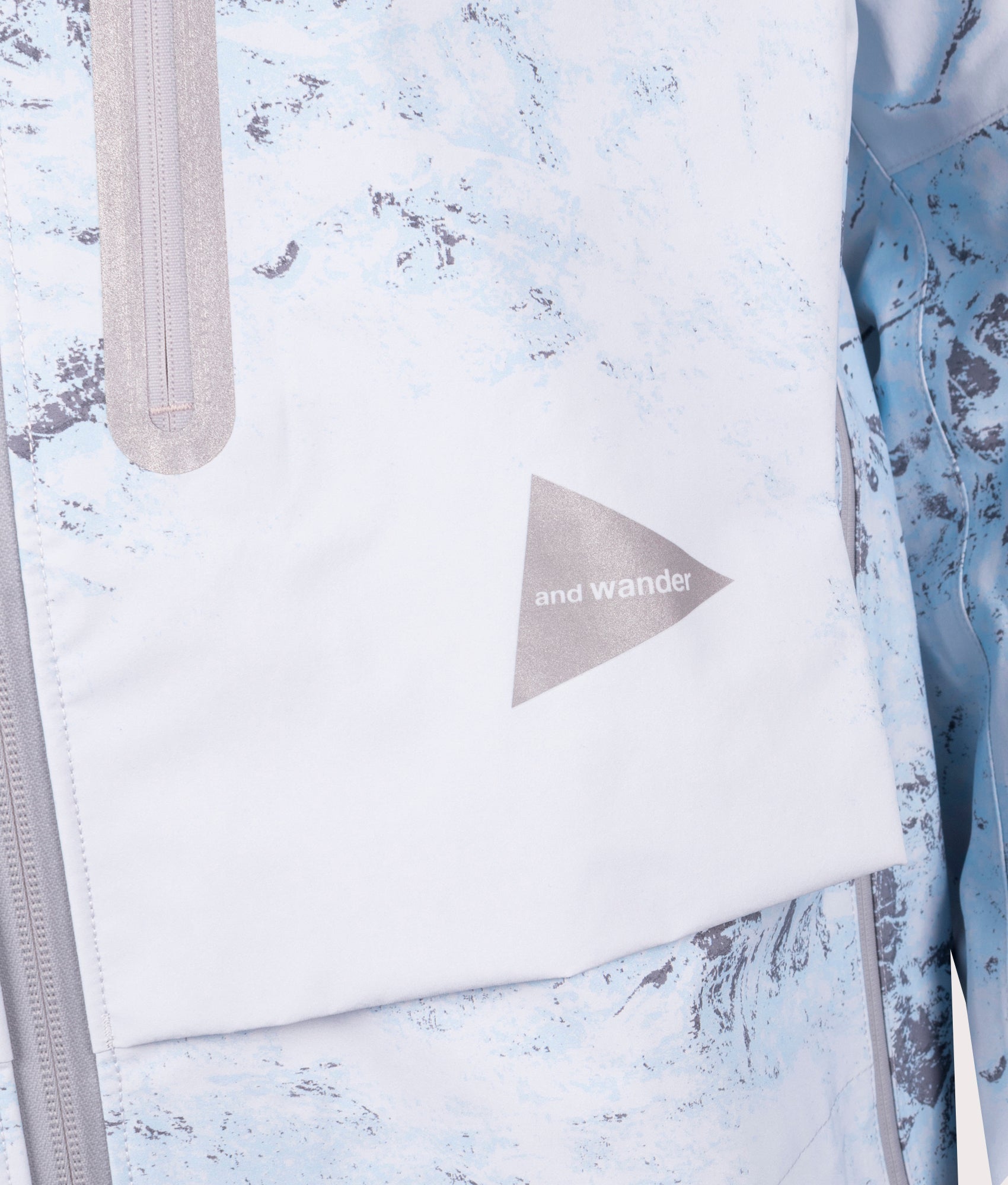 Pertex Shield Rain Jacket in Light Blue by And Wander at EQVVS Menswear. Detail Shot.