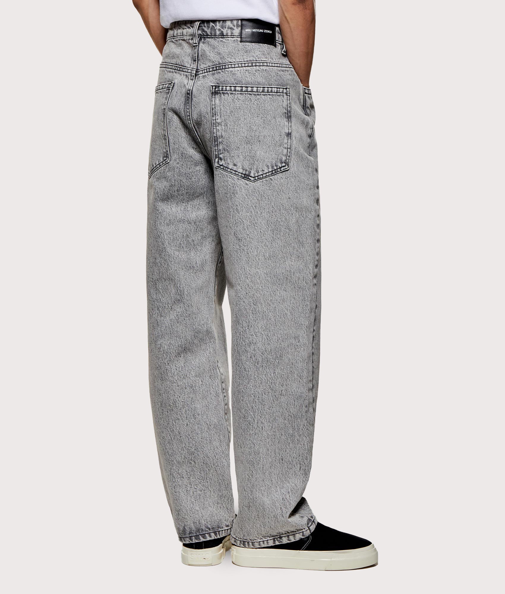MKI MIYUKI ZOKU Denim Classic Jeans in Washed Black at EQVVS Menswear. Angled model back shot.
