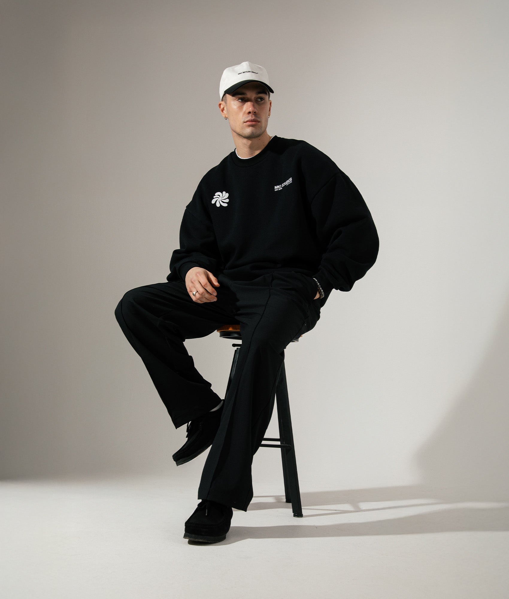 MKI MIYUKI ZOKU Oversized Abstract Crewneck Sweatshirt in Black at EQVVS Menswear. Campaign shot.