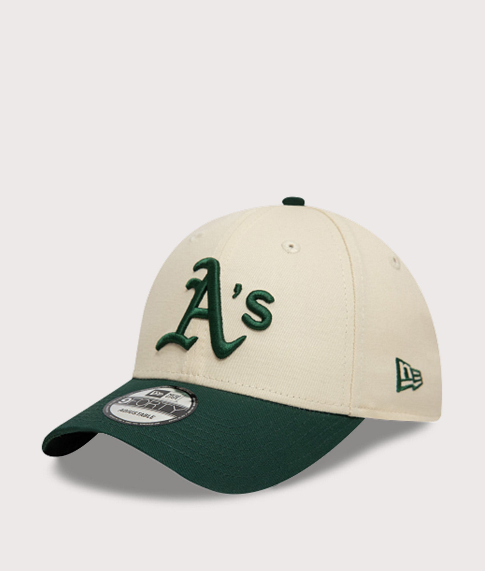 New Era Oakland Athletics Colour Block 9FORTY Adjustable Cap in Cream and Green at EQVVS Menswear. Angled front shot.