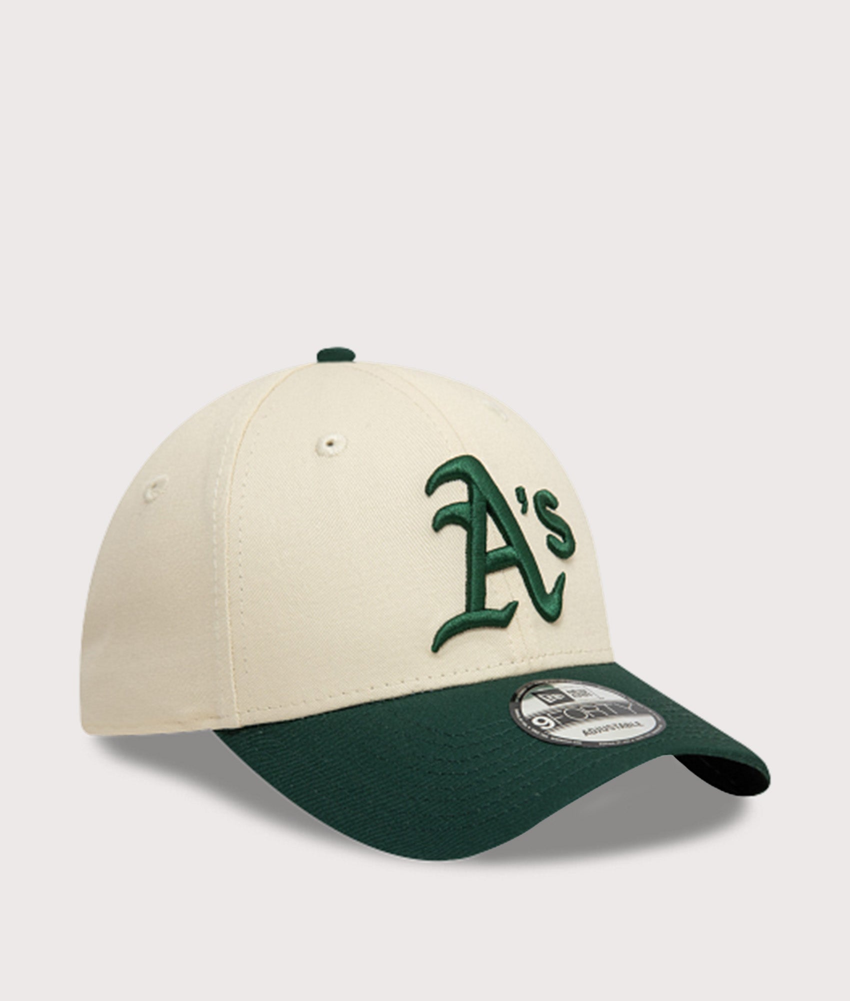 New Era Oakland Athletics Colour Block 9FORTY Adjustable Cap in Cream and Green at EQVVS Menswear. Angled front shot.