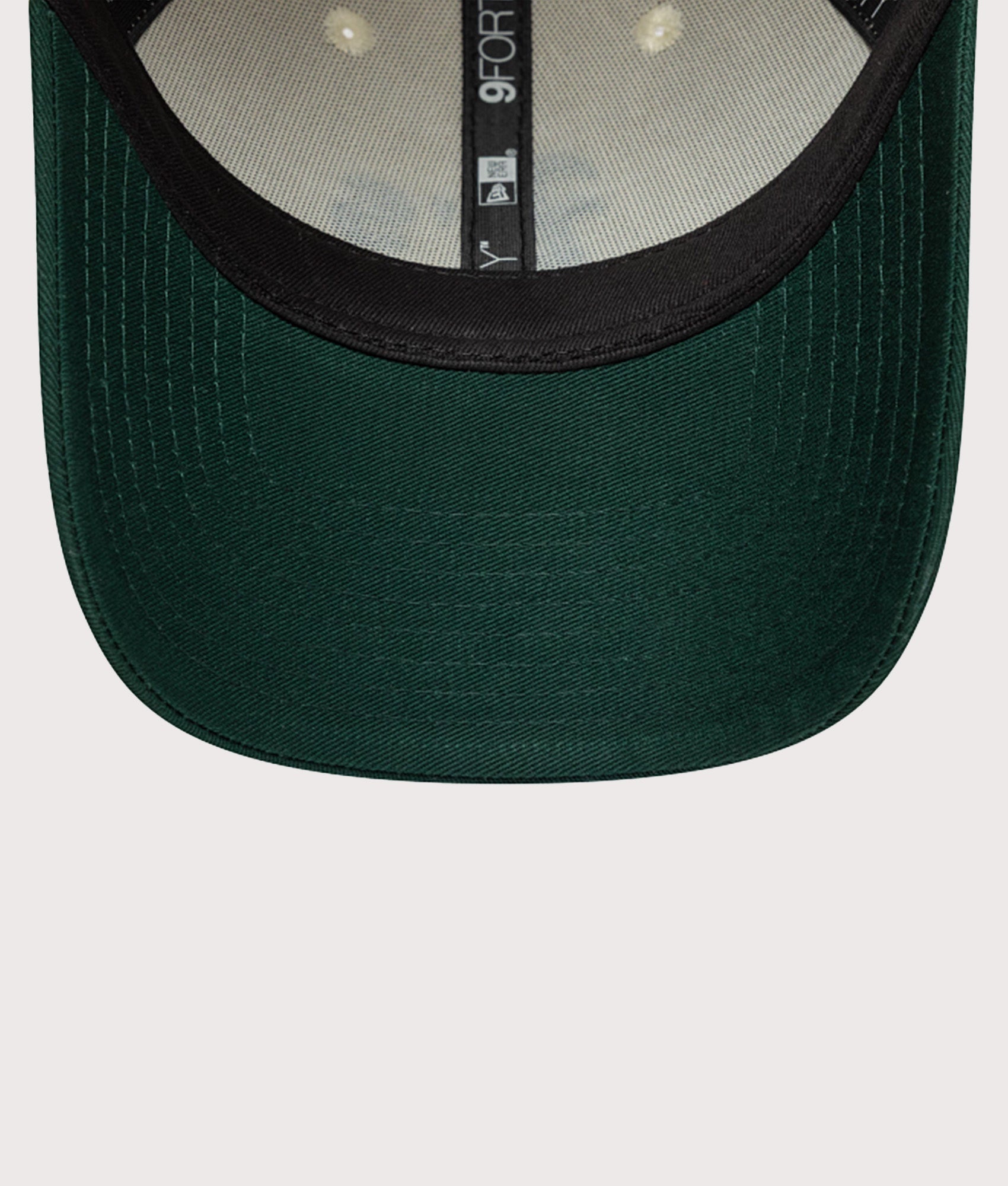 New Era Oakland Athletics Colour Block 9FORTY Adjustable Cap in Cream and Green at EQVVS Menswear. Detail shot.