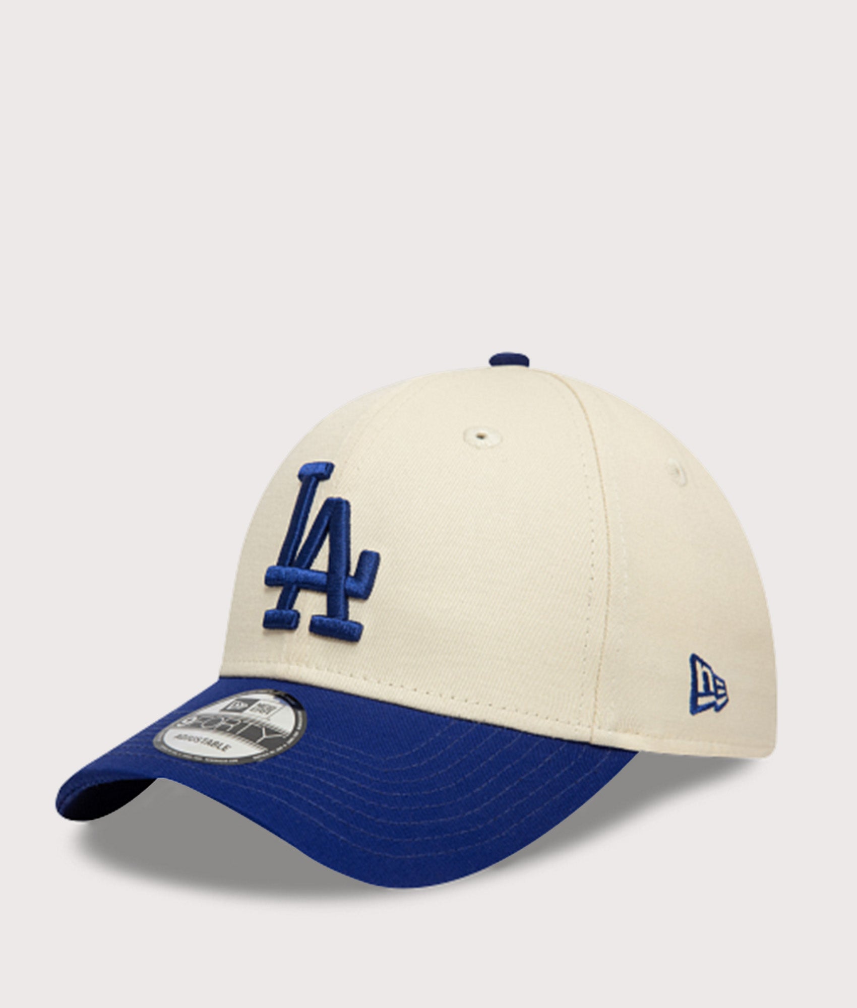 New Era LA Dodgers Colour Block 9FORTY Adjustable Cap in Cream and Blue at EQVVS Menswear. Angled front shot.