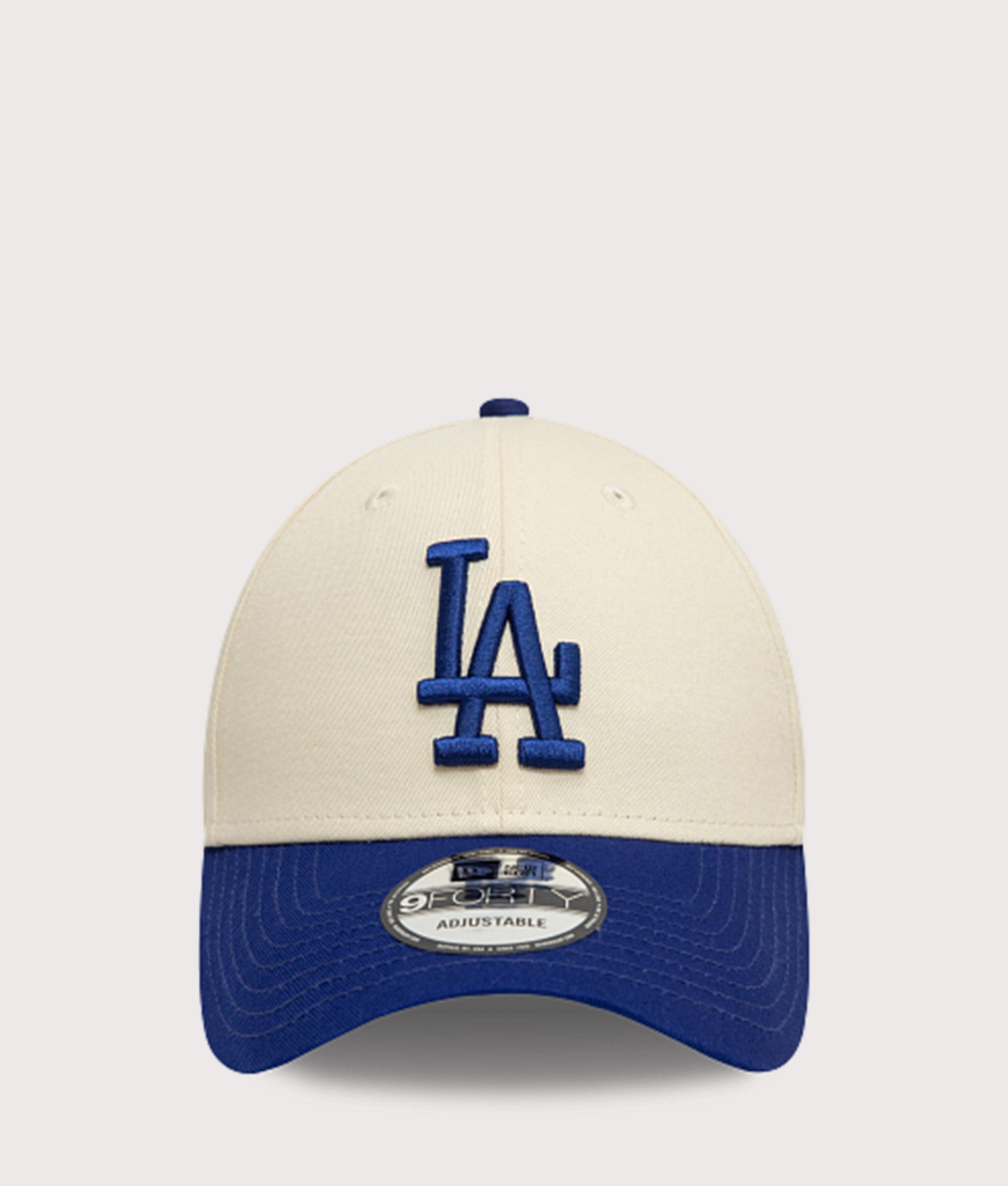 New Era LA Dodgers Colour Block 9FORTY Adjustable Cap in Cream and Blue at EQVVS Menswear. Front shot.