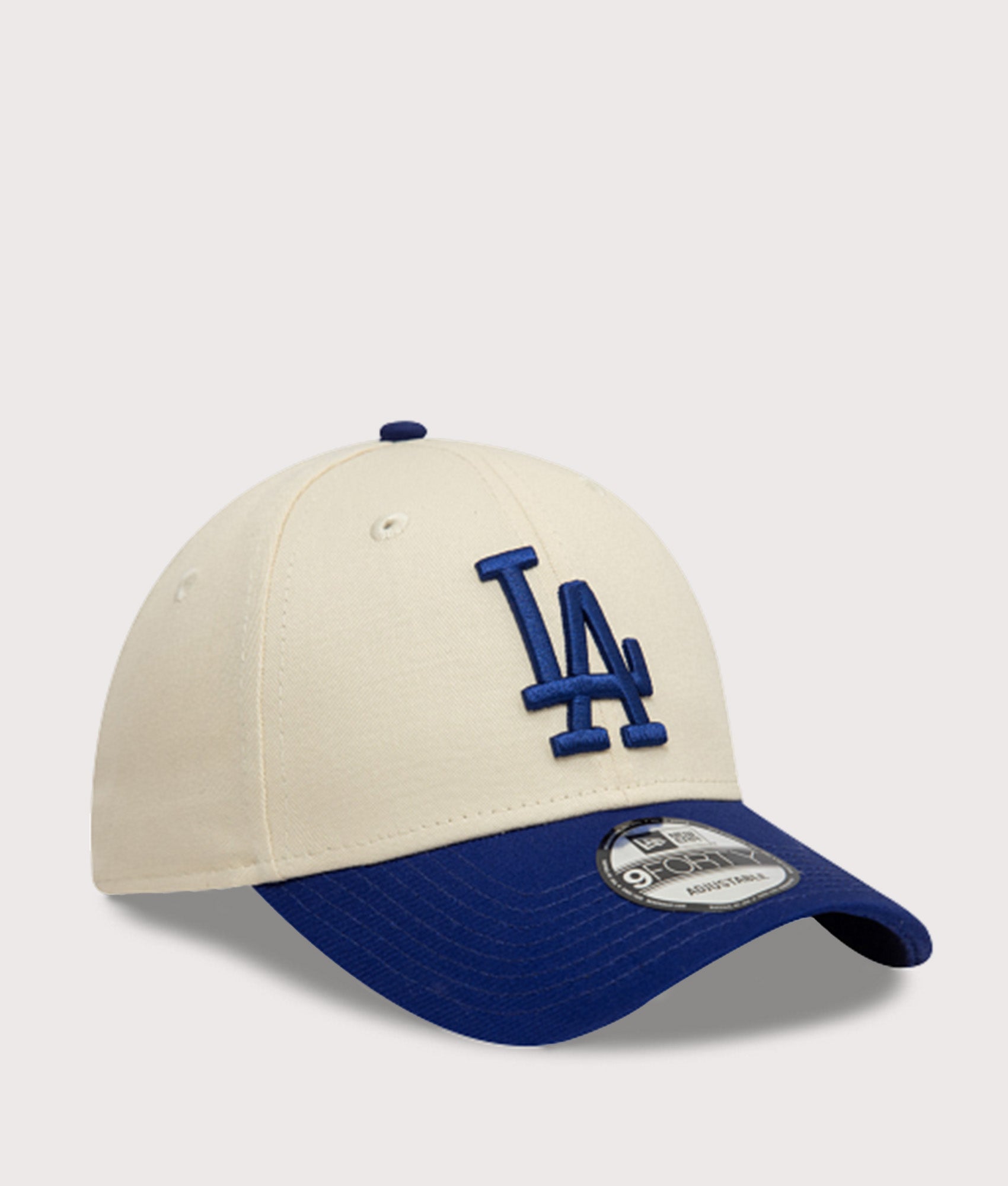 New Era LA Dodgers Colour Block 9FORTY Adjustable Cap in Cream and Blue at EQVVS Menswear. Angled front shot.