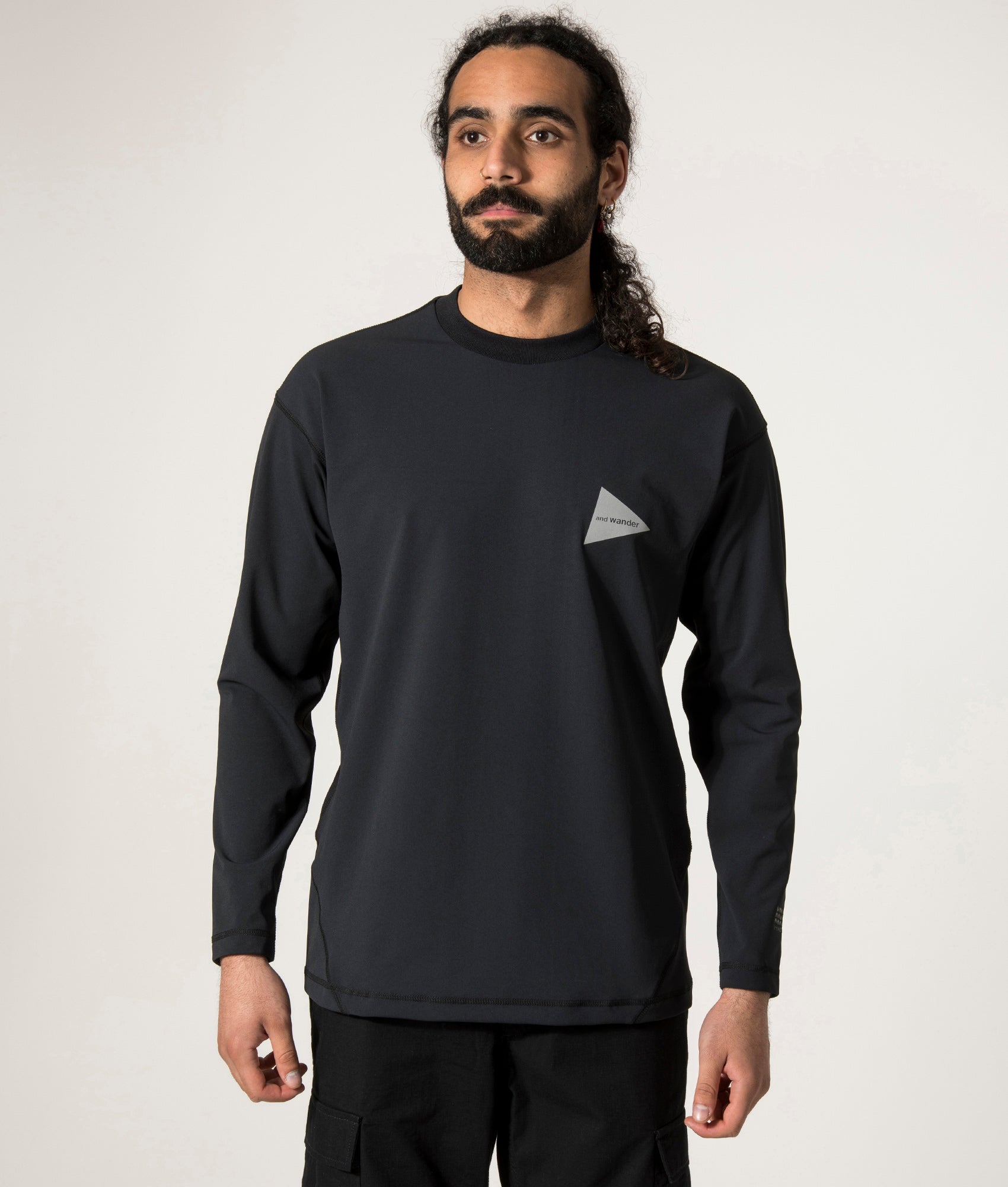 and wander Rash Guard Long Sleeve T-Shirt in Black at EQVVS. Front Model Shot. 