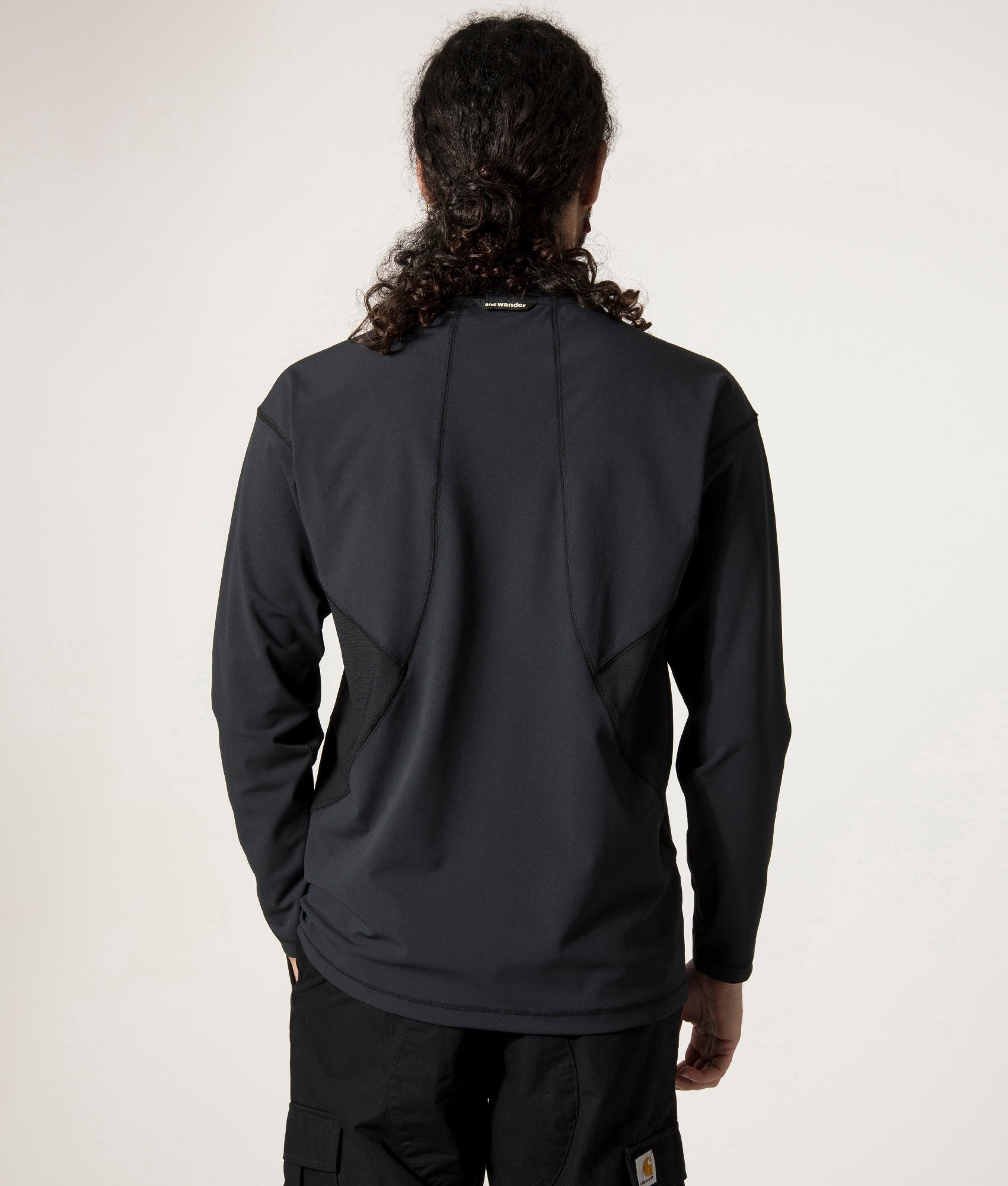 and wander Rash Guard Long Sleeve T-Shirt in Black at EQVVS. Back Model Shot.