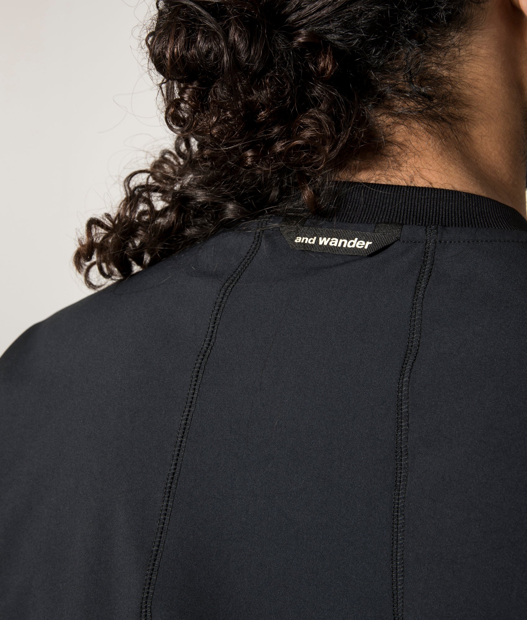 and wander Rash Guard Long Sleeve T-Shirt in Black at EQVVS. Back Detail Model Shot.