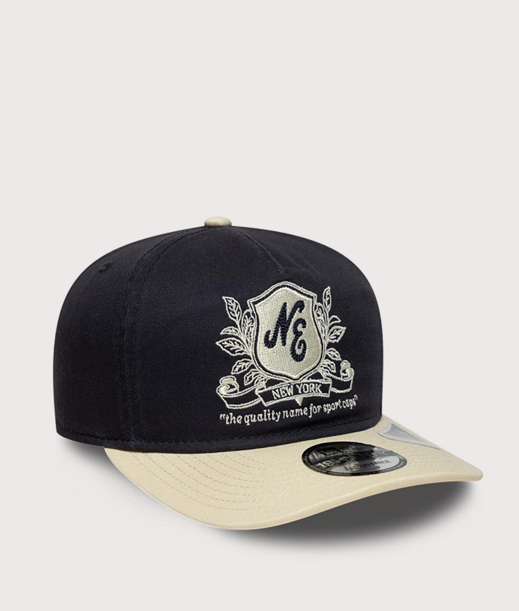 New Era New Era Washed Graphic 19TWENTY Adjustable Cap in Navy and Cream at EQVVS Menswear. Angled front shot.