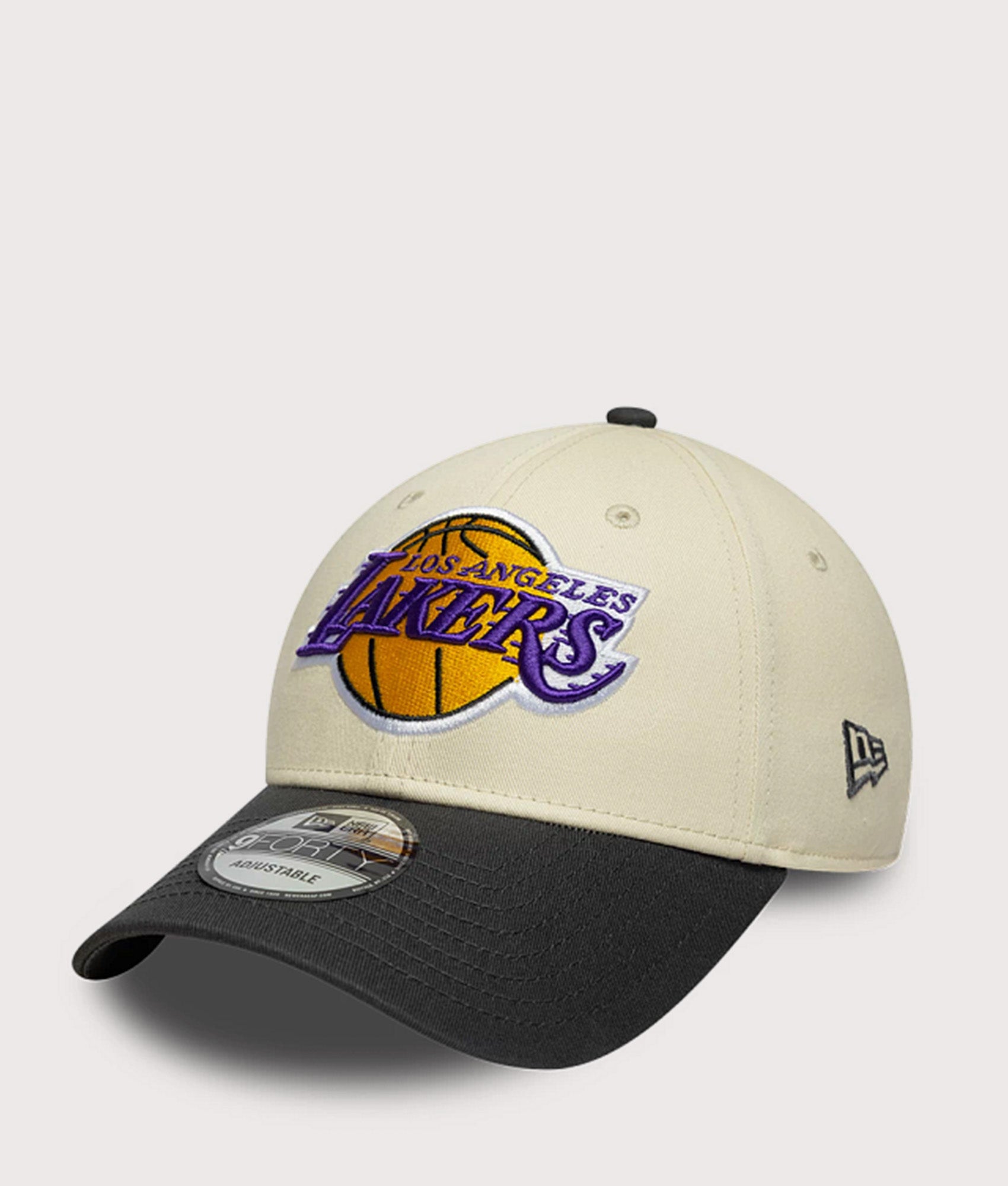 New Era LA Lakers NBA Colour Block 9FORTY Adjustable Cap in Cream and Black at EQVVS Menswear. Angled front shot.