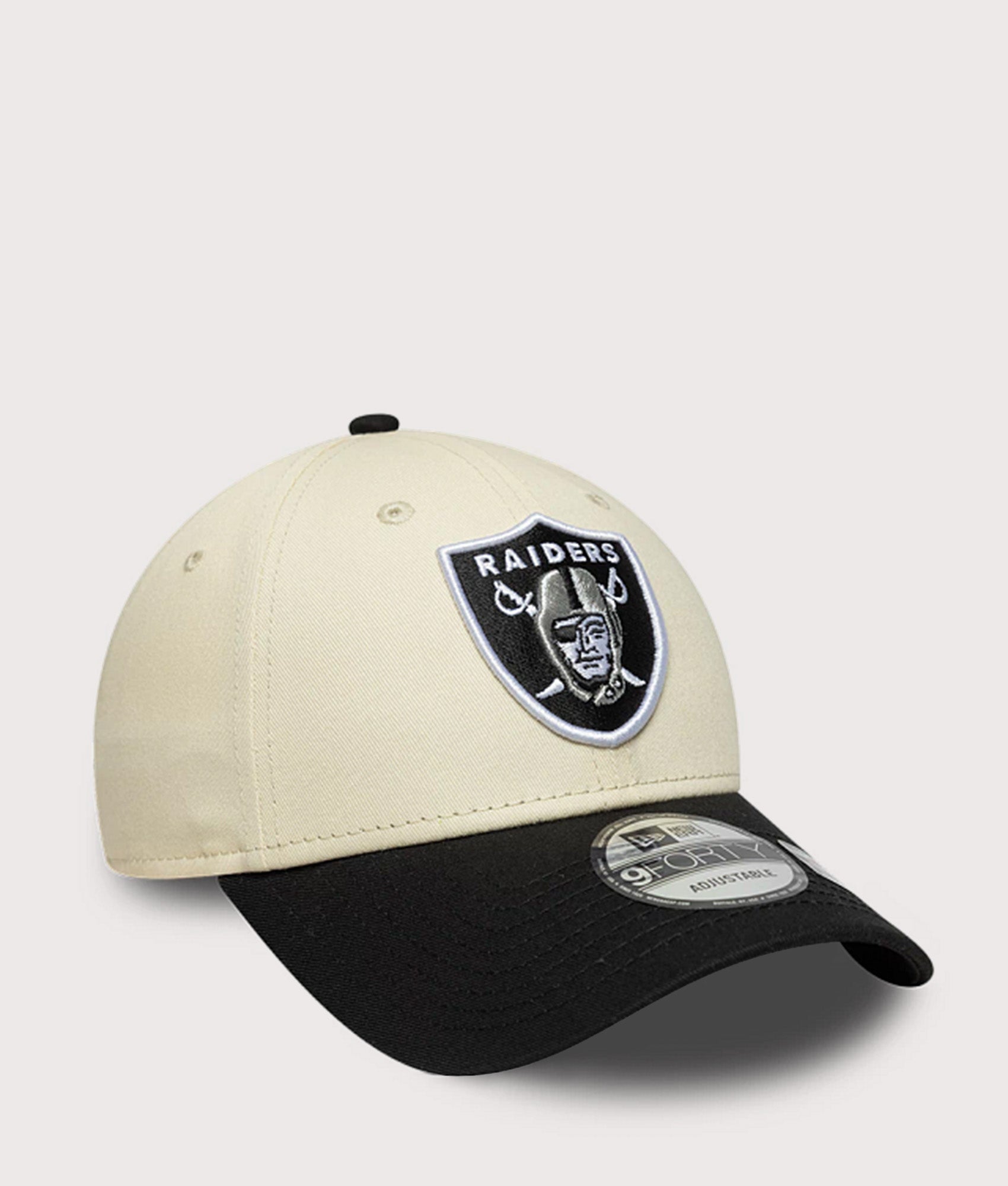New Era Las Vegas Raiders NFL Colour Block 9FORTY Adjustable Cap in Cream and Black at EQVVS Menswear. Angled front shot.