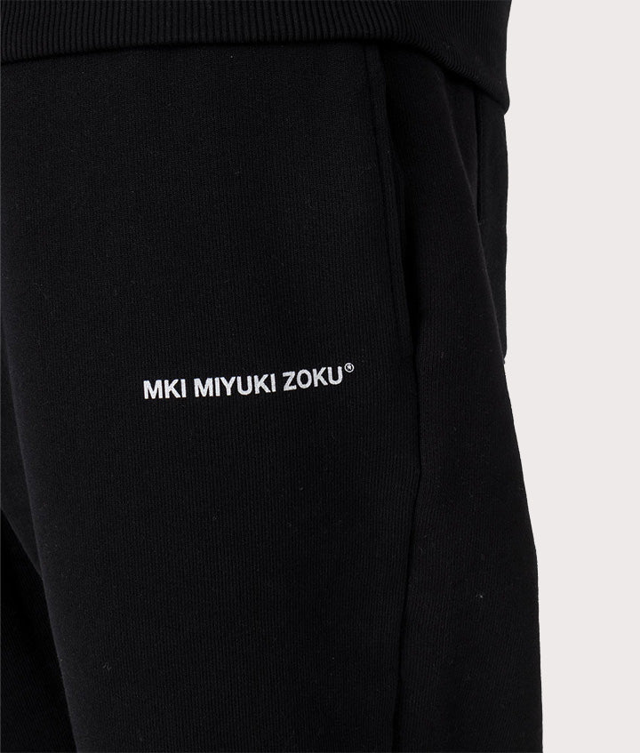 MKI Miyuki Zoku Uniform Joggers in black at EQVVS Menswear. Model detail shot.