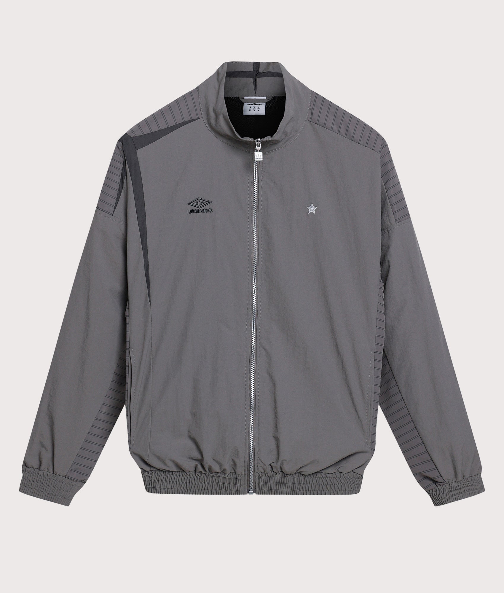 Umbro Relaxed Fit Track Jacket in Brushed Nickel and Volcanic Ash at EQVVS Menswear. Front shot.