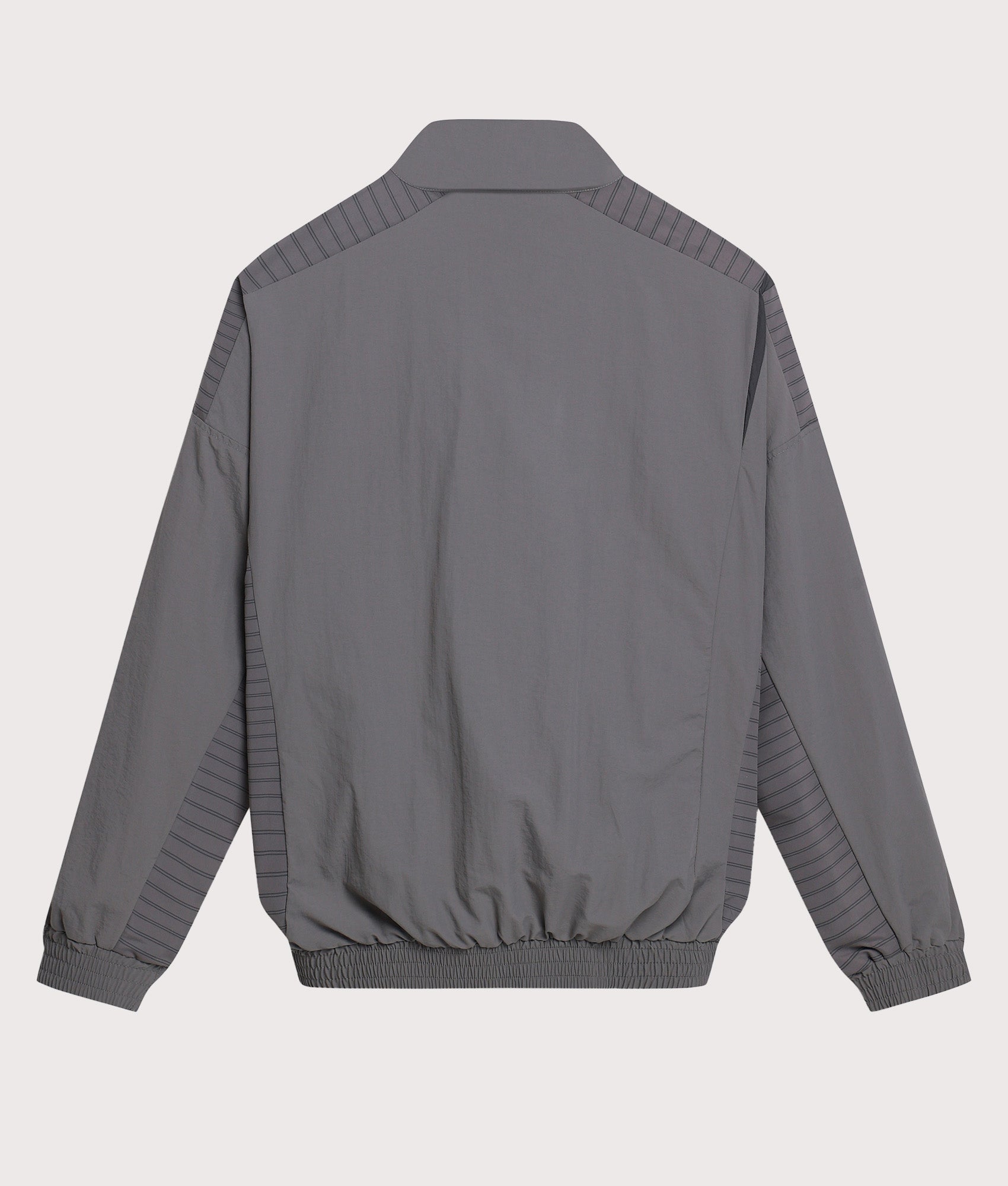 Umbro Relaxed Fit Track Jacket in Brushed Nickel and Volcanic Ash at EQVVS Menswear. Back shot.