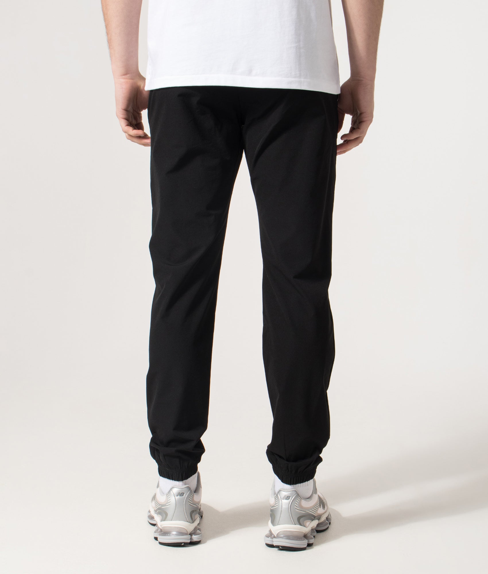 REFLECT Woven Track Pants in Black at EQVVS Menswear.  Model back shot.