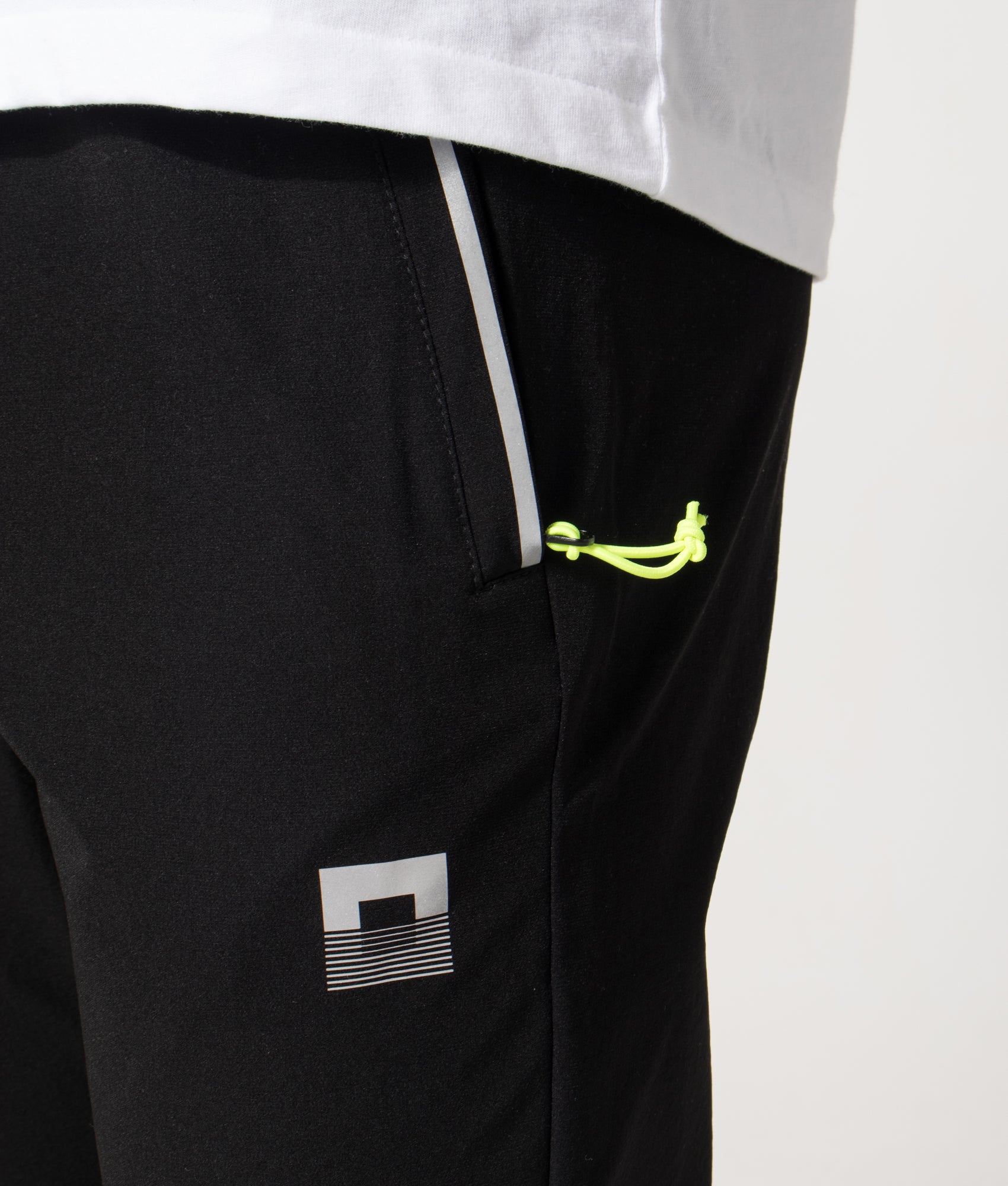 REFLECT Woven Track Pants in Black at EQVVS Menswear. Detail shot.
