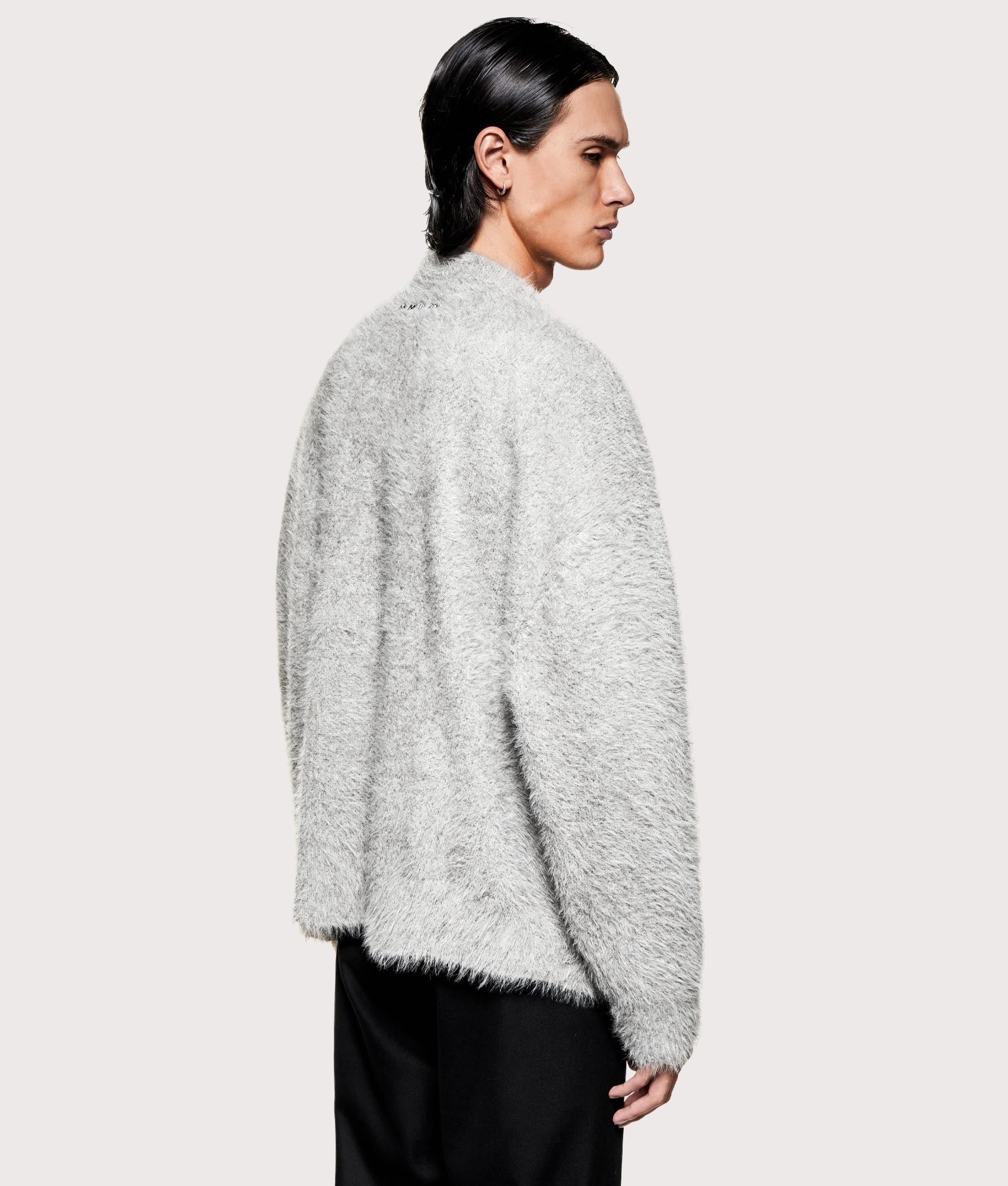 MKI MIYUKI ZOKU Faux Alpaca Knit Crewneck Jumper in Grey Melange at EQVVS Menswear. Angled model back shot.