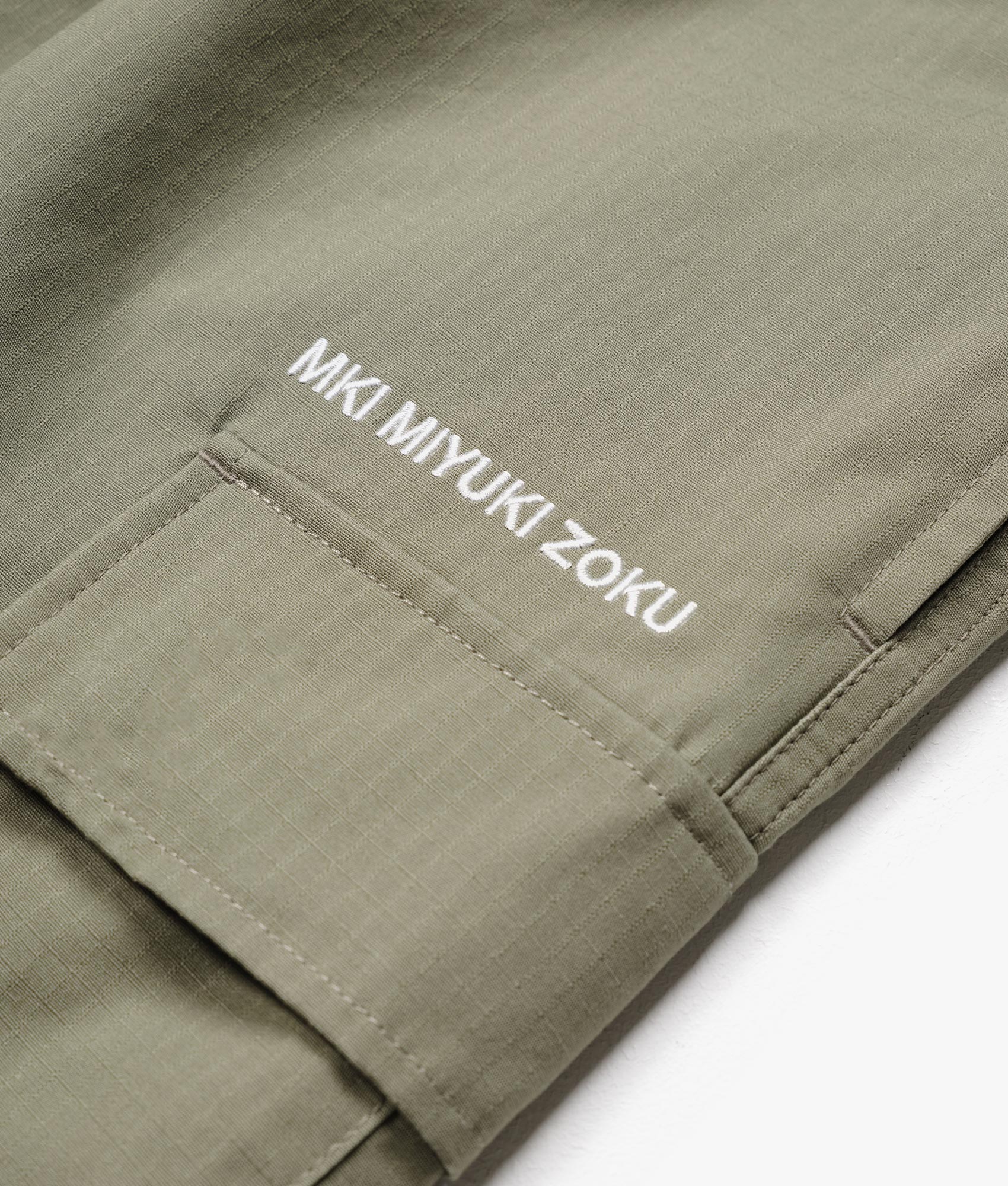 Relaxed Fit Ripstop Cargo Shorts in Sage Green by MKI MIYUKI ZOKU. EQVVS Detail Shot.