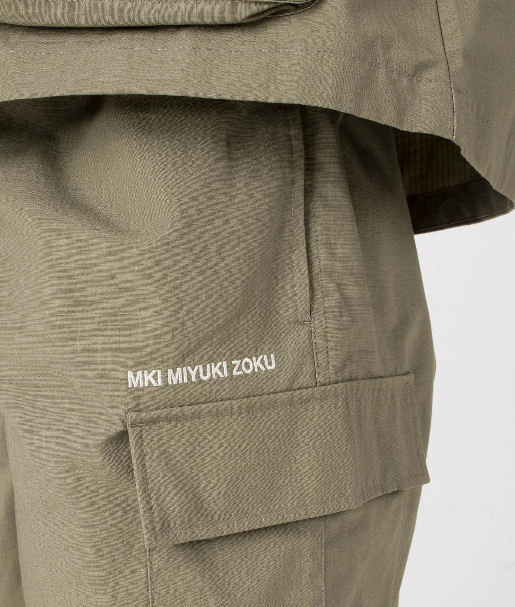 MKI Relaxed Fit Ripstop Cargo Shorts in Sage Green. Detail angle model shot at EQVVS.