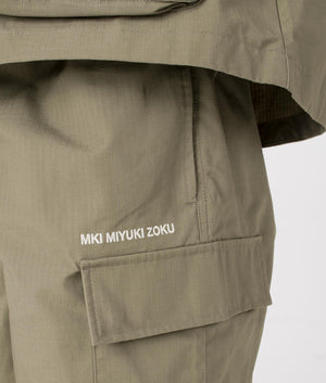 MKI Relaxed Fit Ripstop Cargo Shorts in Sage Green. Detail angle model shot at EQVVS.