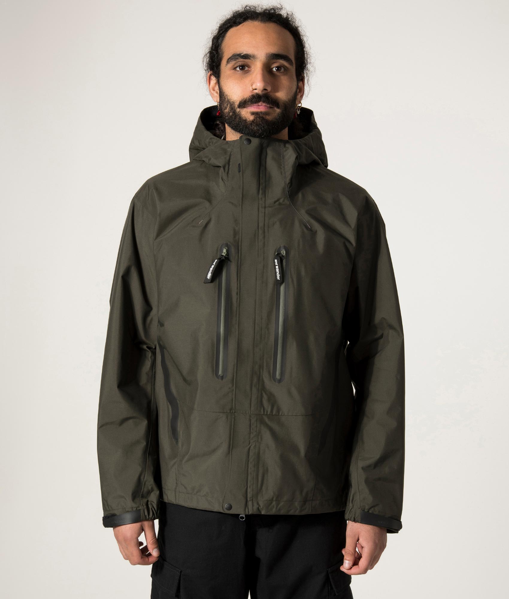 and wander 2.5L Hiker Rain Jacket in Dark Khaki. Front Model Shot at EQVVS