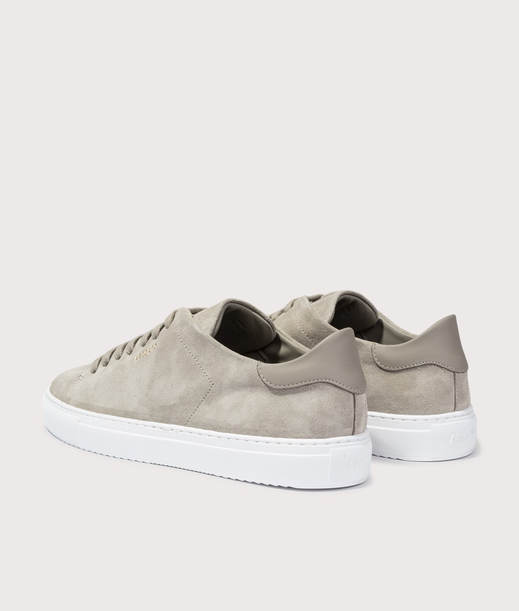 Axel Arigato Clean 90 Suede Sneaker in Beige and White at EQVVS Menswear. Angled back shot.