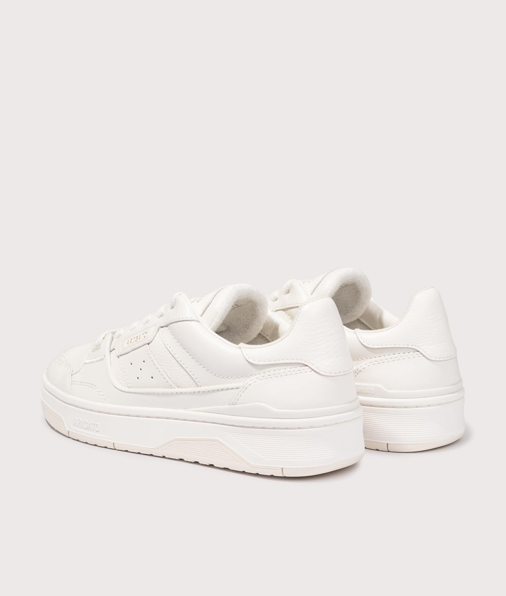 Axel Arigato Clay sneakers in Off White at EQVVS Menswear. Angled back shot.
