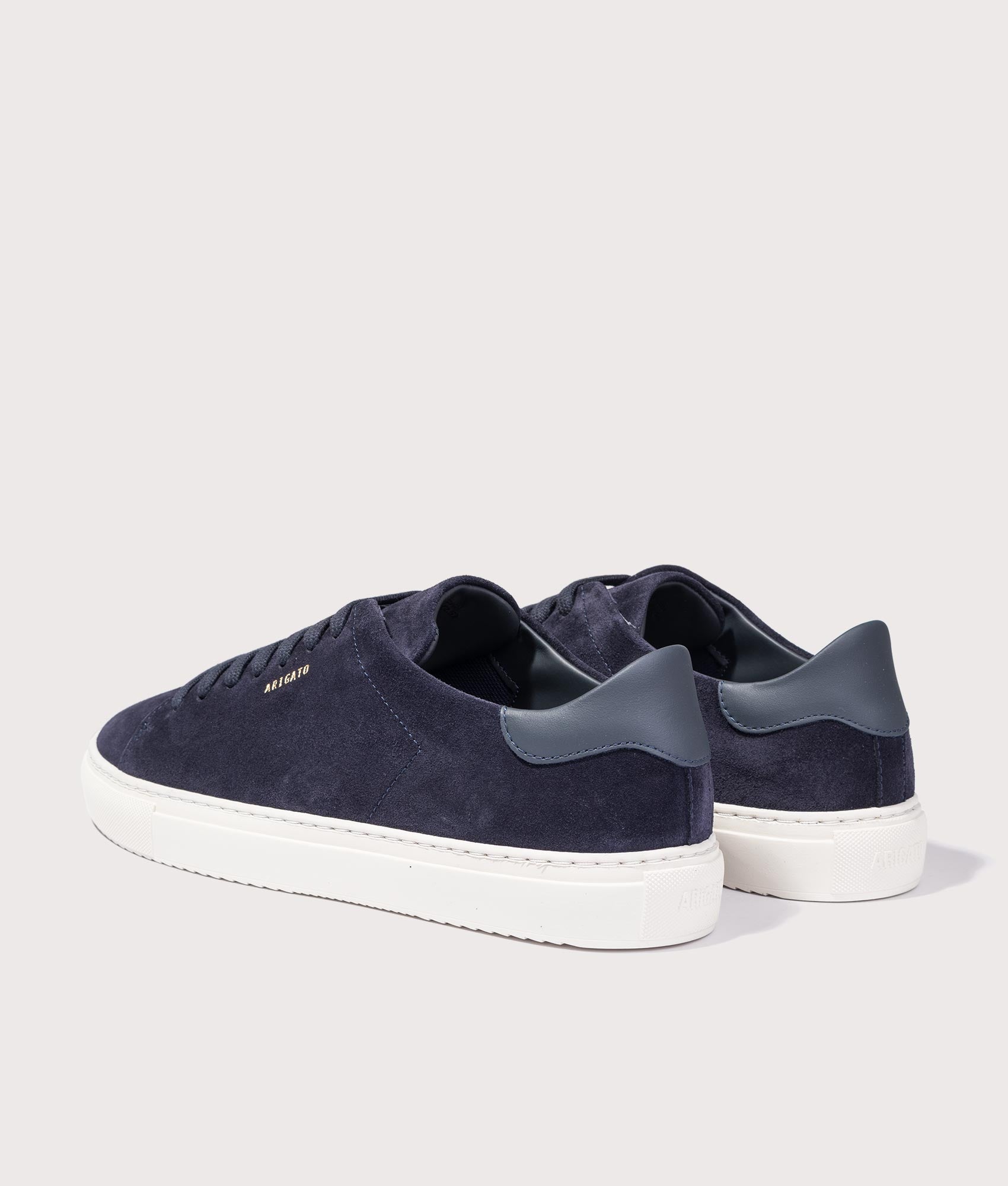 Axel Arigato Clean 90 Suede Sneakers in Dark Blue and Off White at EQVVS Menswear. Angled back shot.