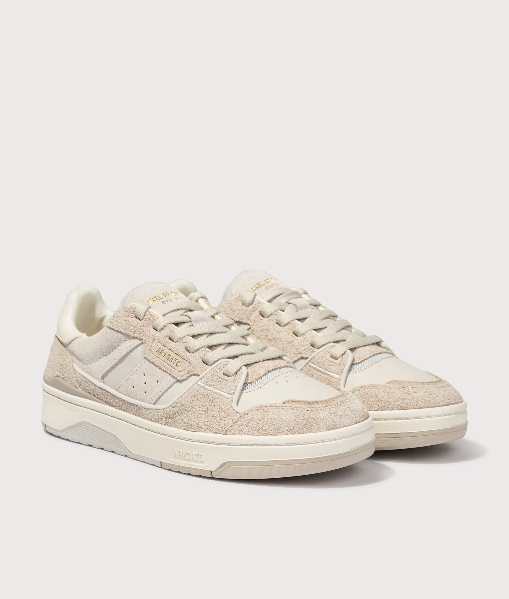 Axel Arigato Clay Sneakers in Beige and Light Taupe at EQVVS Menswear. Angled front shot.