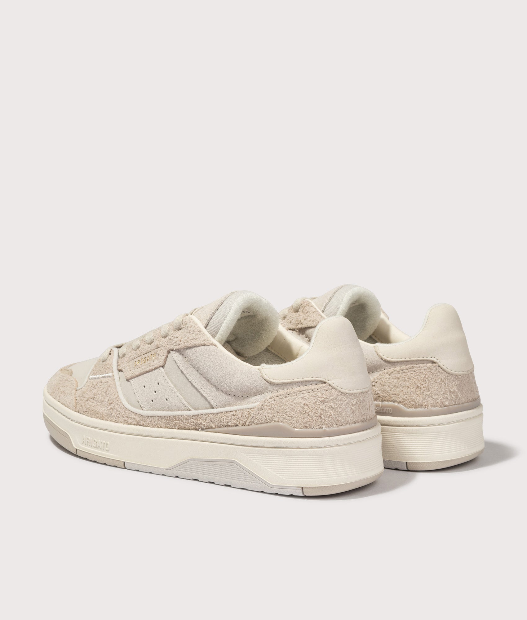Axel Arigato Clay Sneakers in Beige and Light Taupe at EQVVS Menswear. Angled back shot.