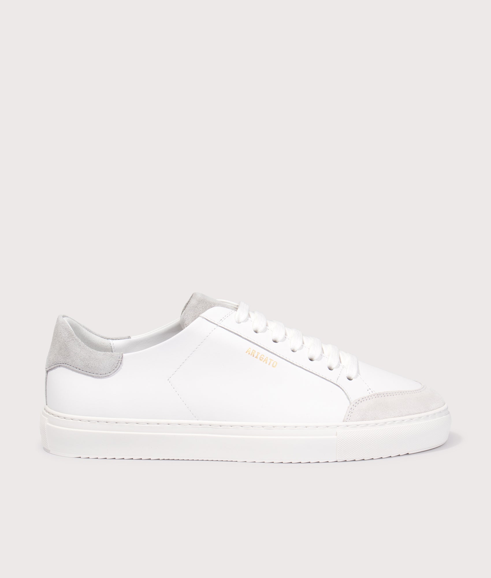 Axel Arigato Clean 90 Triple Sneakers in White/Grey at EQVVS Menswear. Side shot.