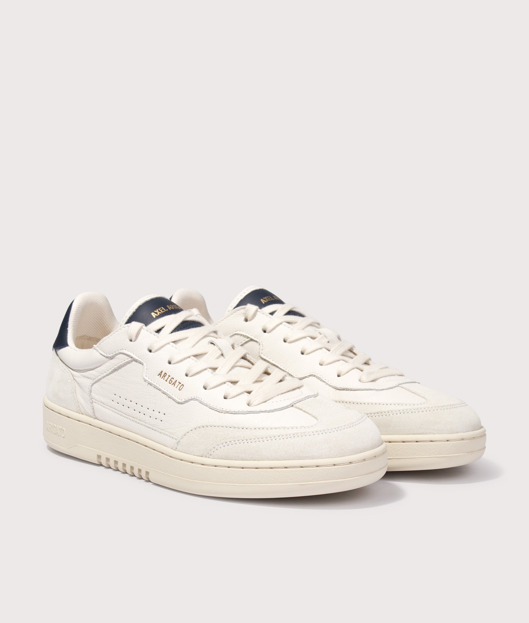 Axel Arigato Dice T-Toe Sneakers in Light Beige and Dark Blue at EQVVS Menswear. Angled front shot.