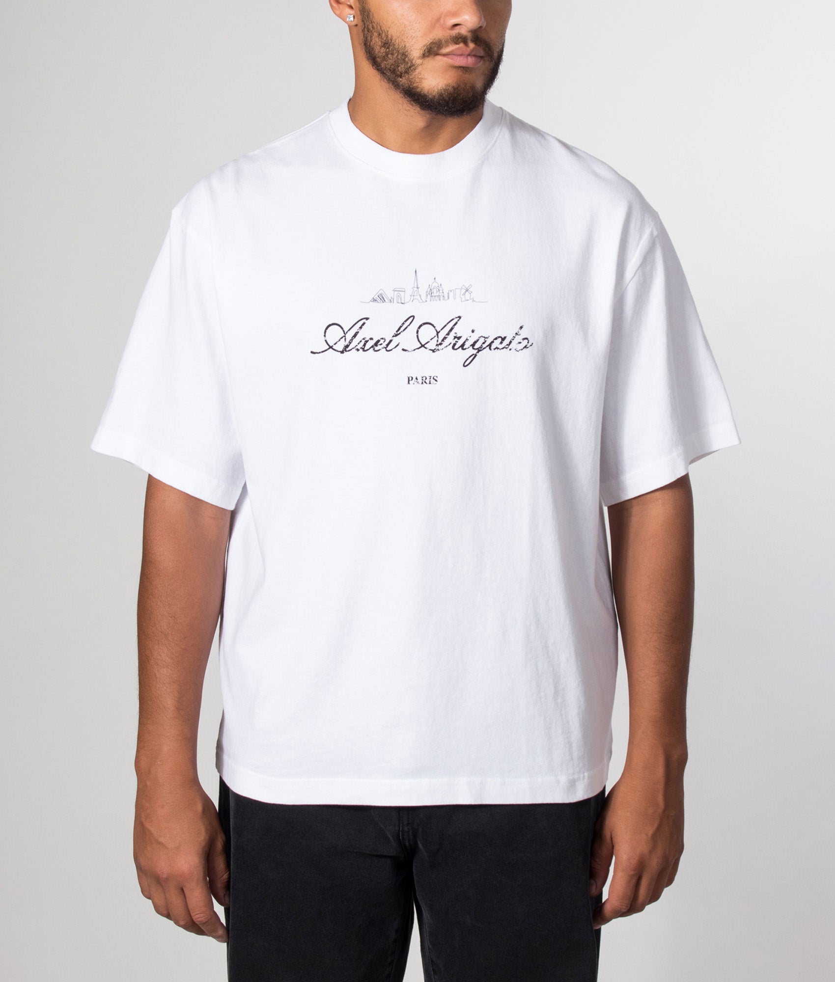 Axel Arigato Oversized Fit Paris Sky T-Shirt in White at EQVVS Menswear. Model front shot.